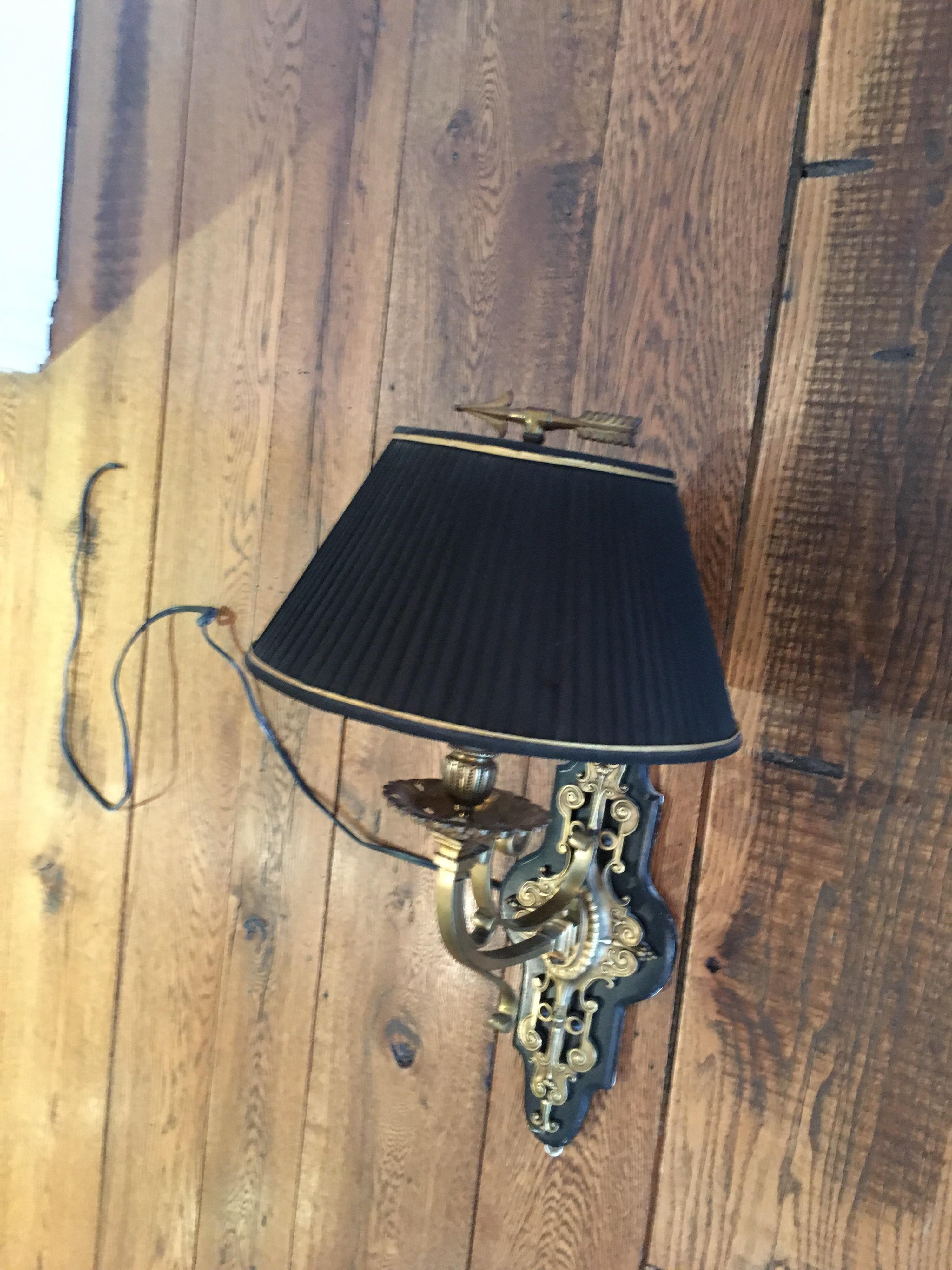 Custom brass weathervane fragment single arm sconce.
Measures: 15.5