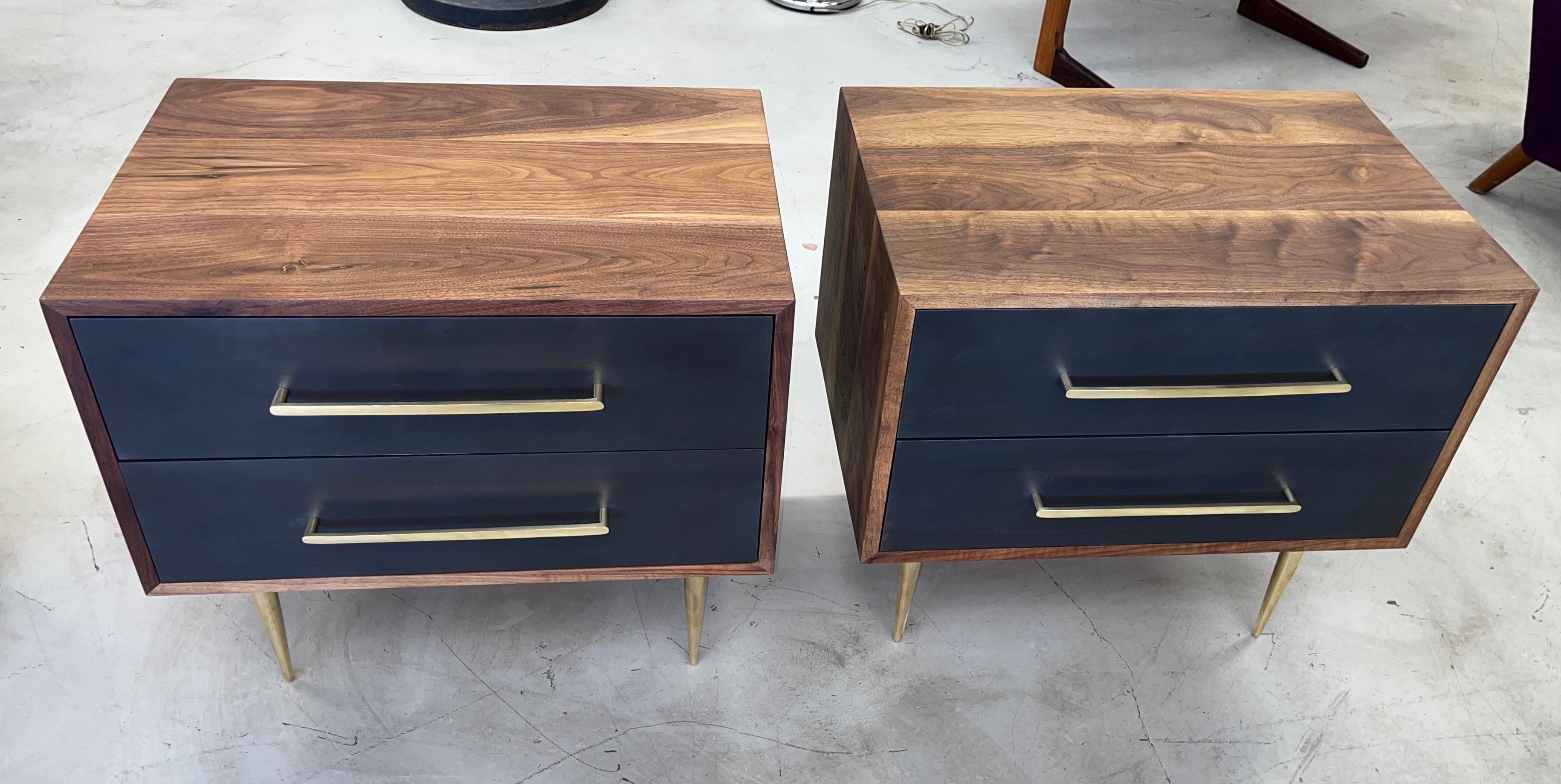 Beautiful pair of custom made solid walnut bodied nightstands with iron coated drawer fronts. 2 drawers each. Solid brass Italian drawer pulls and solid brass tapered legs. Beautiful graining to the wood with finished backs. The drawers are