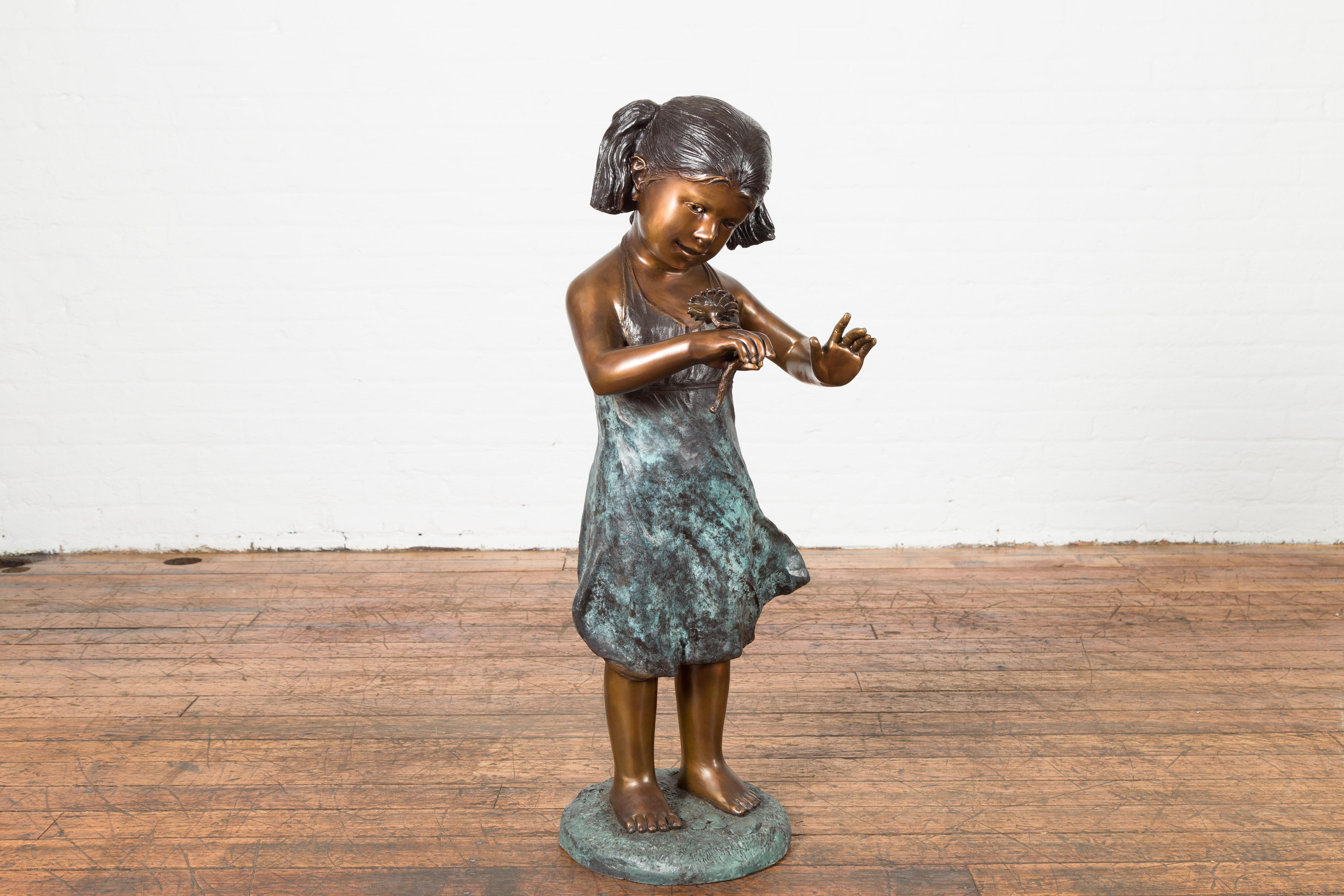 Cast Bronze Garden Statue of a Girl Holding a Flower in Her Hand on Base For Sale