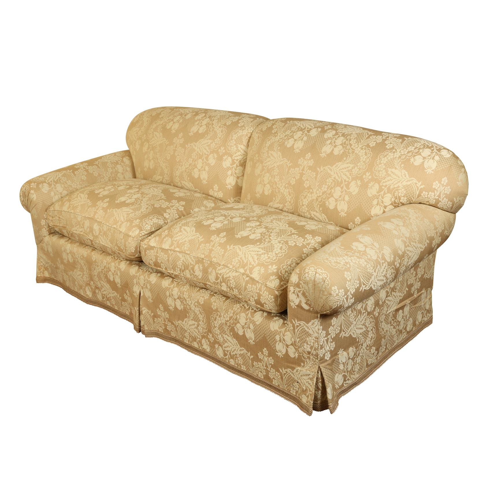 English roll arm two cushion sofa upholstered in neutral floral custom Brunschwig & Fils fabric.