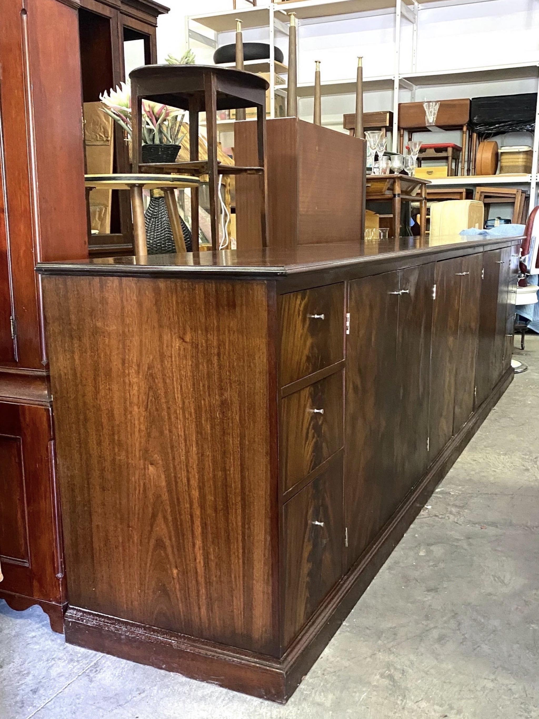 This extra long credenza was custom built for a high end car dealership. It has 3 drawers on each end and 3 double door cabinets, providing tons of storage. This is a near flawless piece and in the right settings, is so functional. Would look great