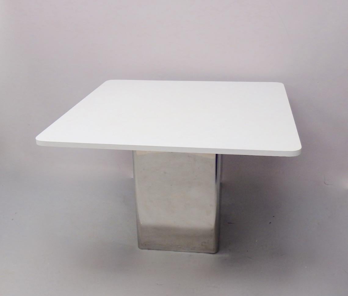 Listing is for one table. There are two of these available. Incredibly well made overbuilt steel frame inside of seamless stainless steel pedestal. 3/8 thick steel top flange holds the white lament tops. These could be used to support one large