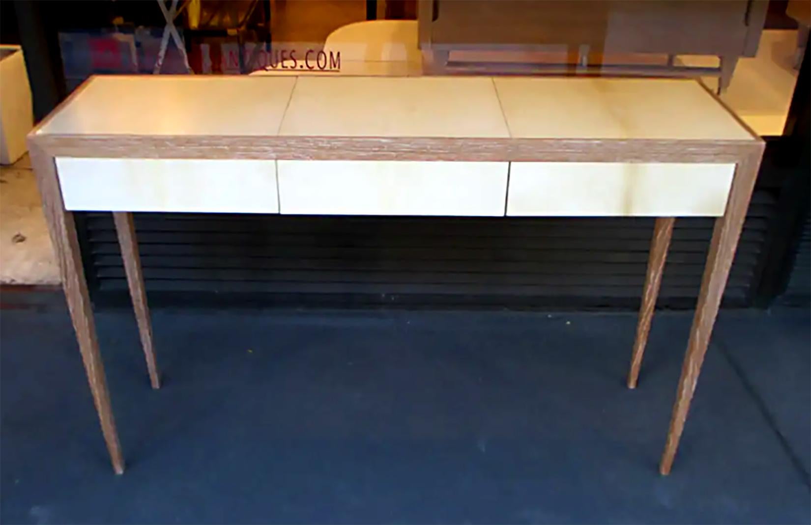 A custom cerused-oak and parchment console table in the Jean Michel Frank Manner. Lead Time is 8-10 weeks.
