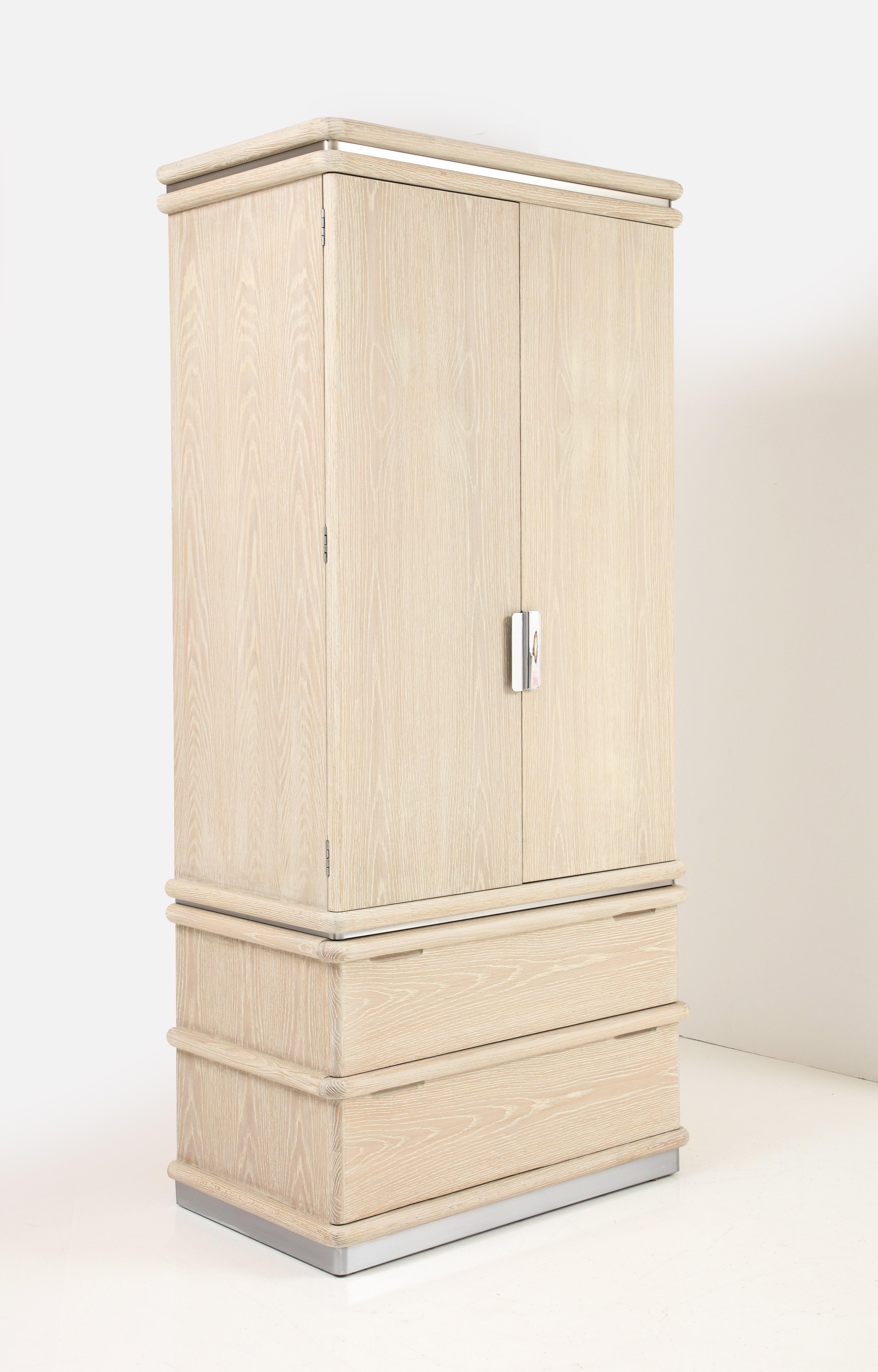 Custom Finished, Cerused Oak wardrobe by Jay Spectre for Century Furniture. Wardrobe features 2 large bottom drawers and doors open to reveal a series of cubicles and smaller drawers. Recently mint restored in a sand colored cerused finish. Signed.