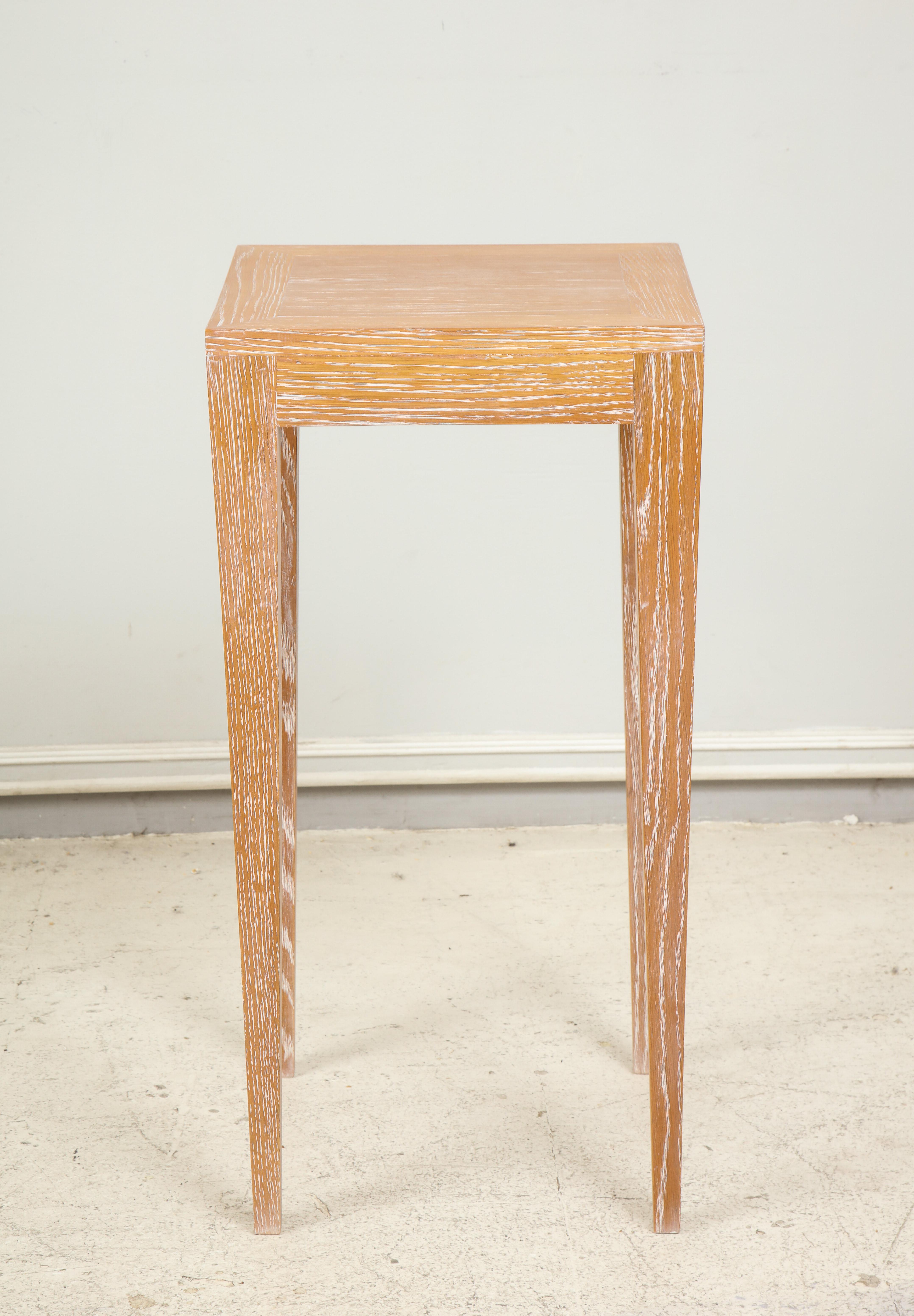 Custom cerused oak table on tapered legs.
