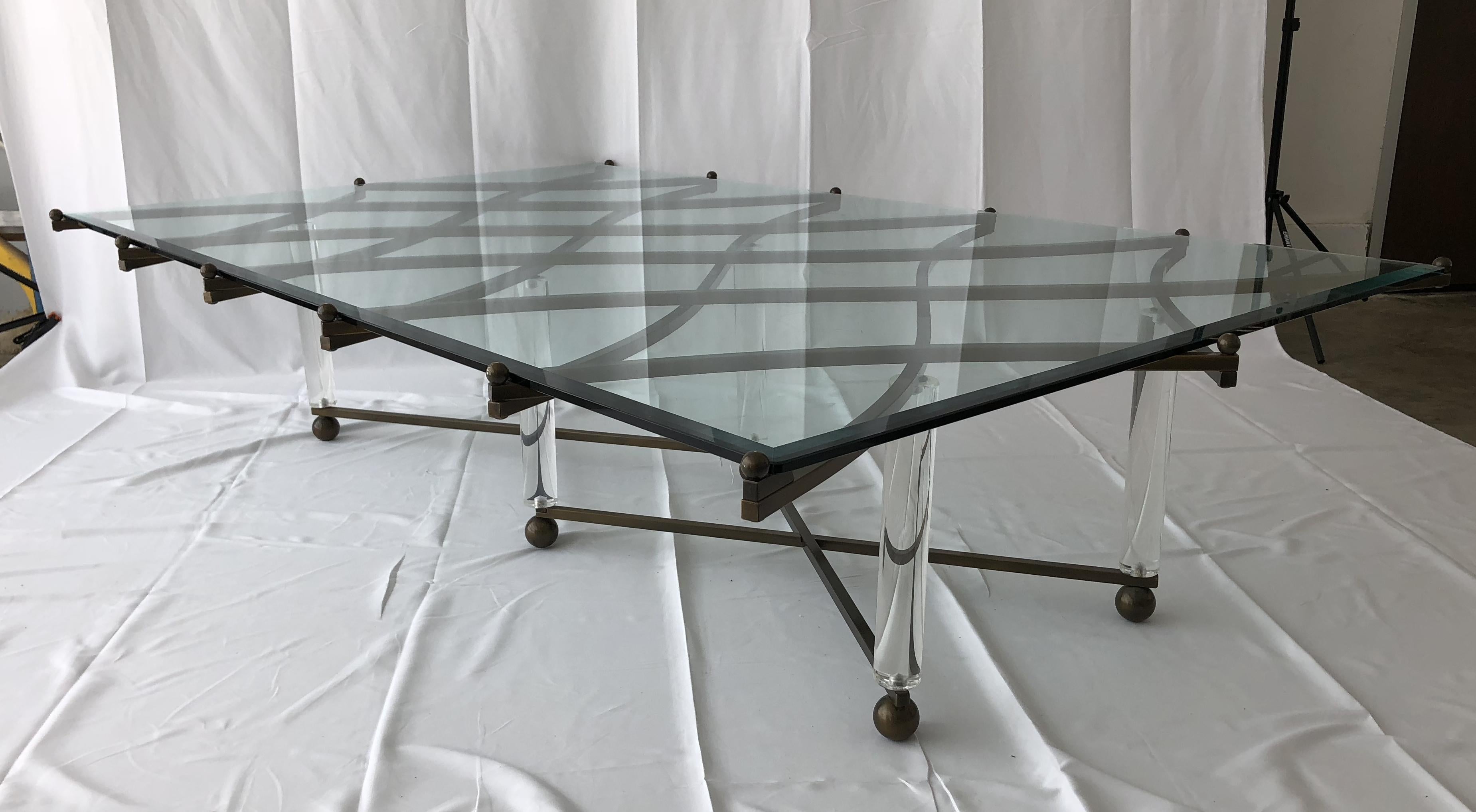 This amazing brass and Lucite coffee table by Hollis Jones is quite possibly his most exquisite design. 
Known for his innovation with the use of Lucite and metal, Hollis Jones is a master at combining elegance and wit. The brass lattice work of