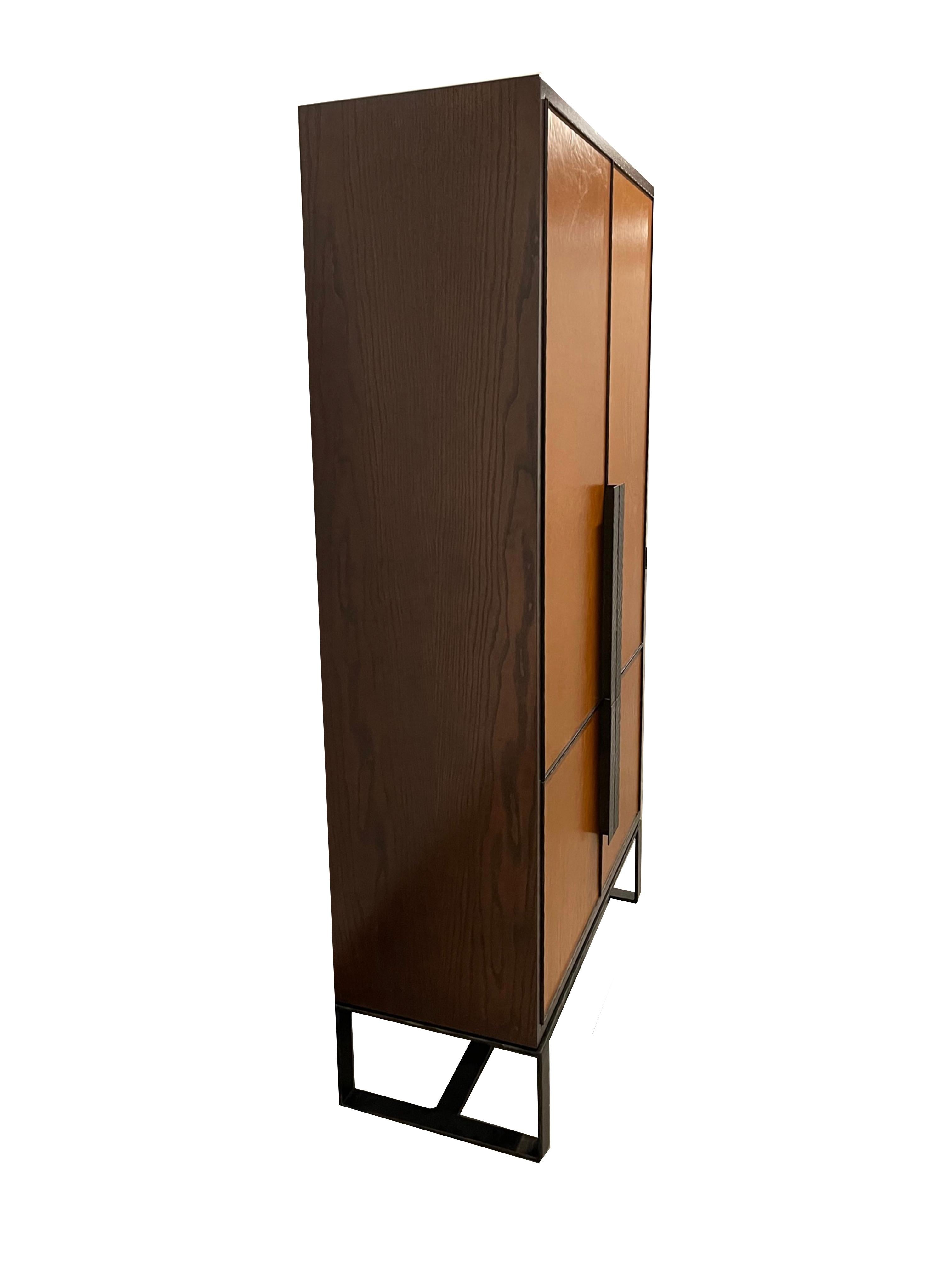 The Chelsea leather bar cabinet by Ercole Home is a 4 door metal framed Bar / serving area. This piece is equipped with two compartments, in the larger of the two is the main bar area consisting of four drawers for storage, a touch latch shelf, and