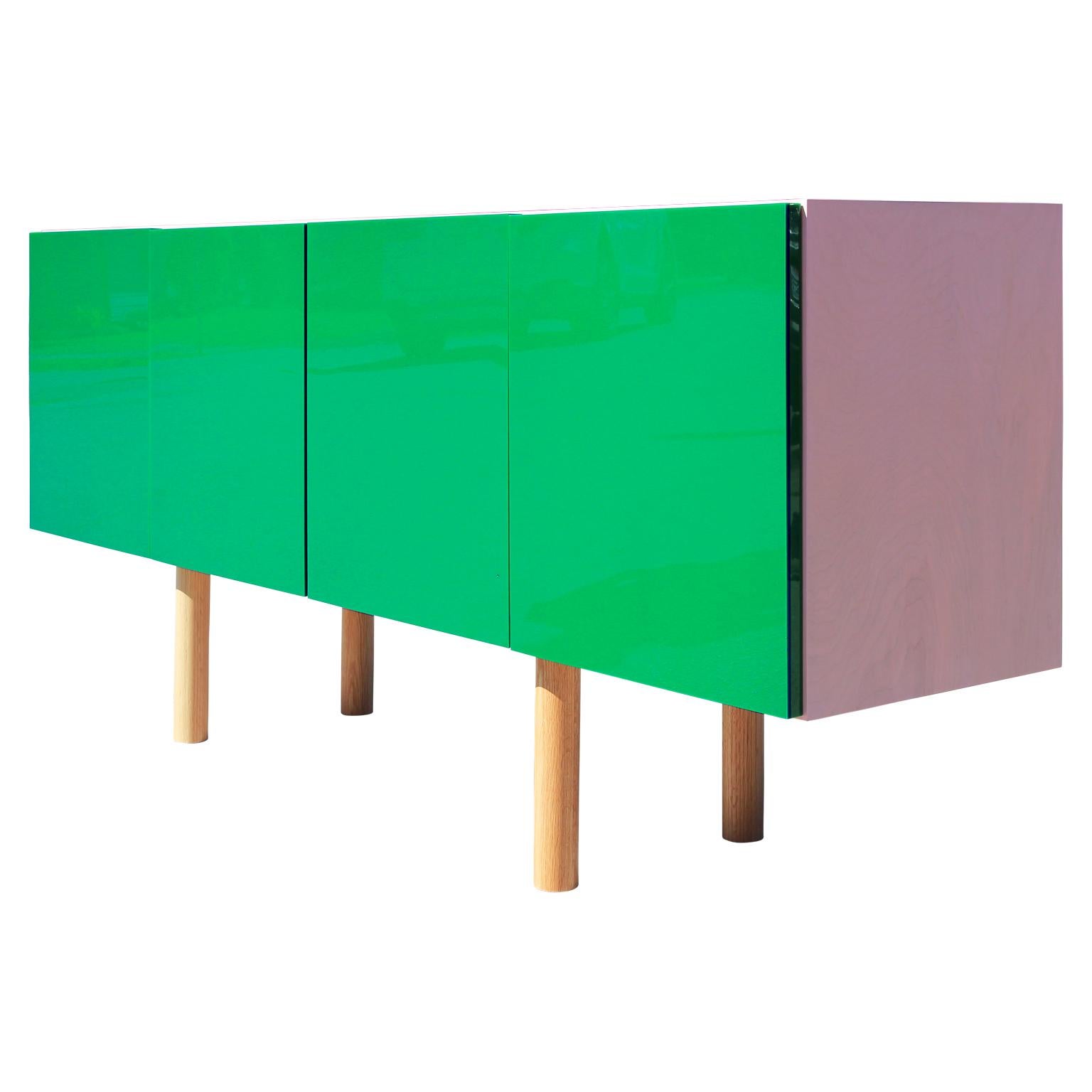 Knockout custom designed handmade contemporary sideboard with green lucite doors with a pink casing. The legs are smoothly turned, creating a clean and sleek appearance.
- Can be made to order in and various finishes and sizes
- Oak
