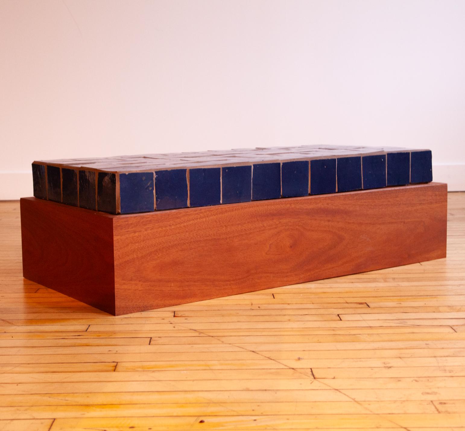 Custom contemporary coffee table made with glossy blue tile and mahogany. 

Fantastic piece. 

Tile grouting is not highly refined, but the overall design is very cool and striking.

Base in hallow. Very heavy still.

Ships from Philadelphia.