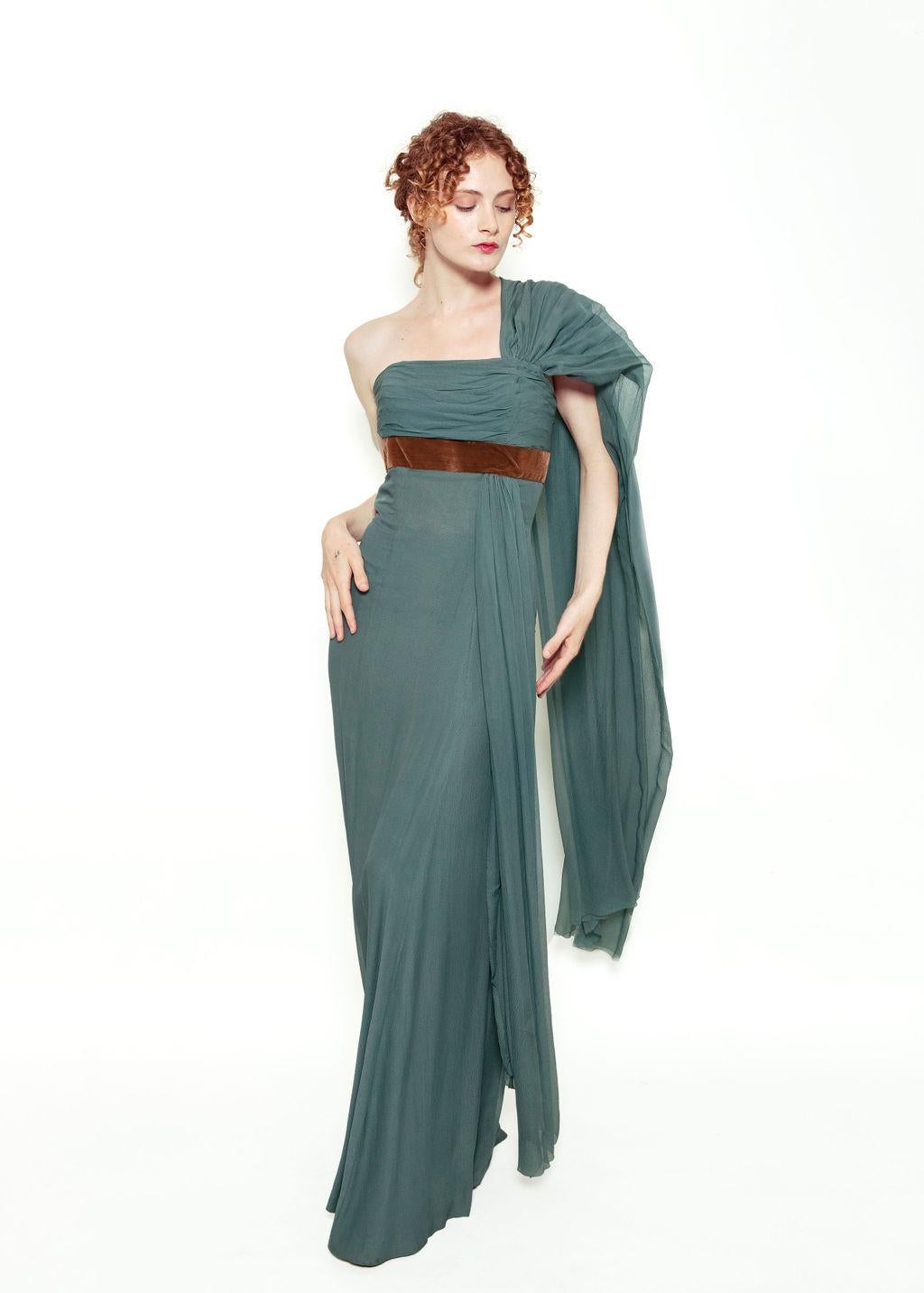 Turn heads and make a statement in this one-of-a-kind Custom Dress that was made for the Queens Maiden of Sweden, Birget Pontin. 

Featuring a stunning blue silk chiffon and brown velvet waist to create the perfect hourglass silhouette.  It has a