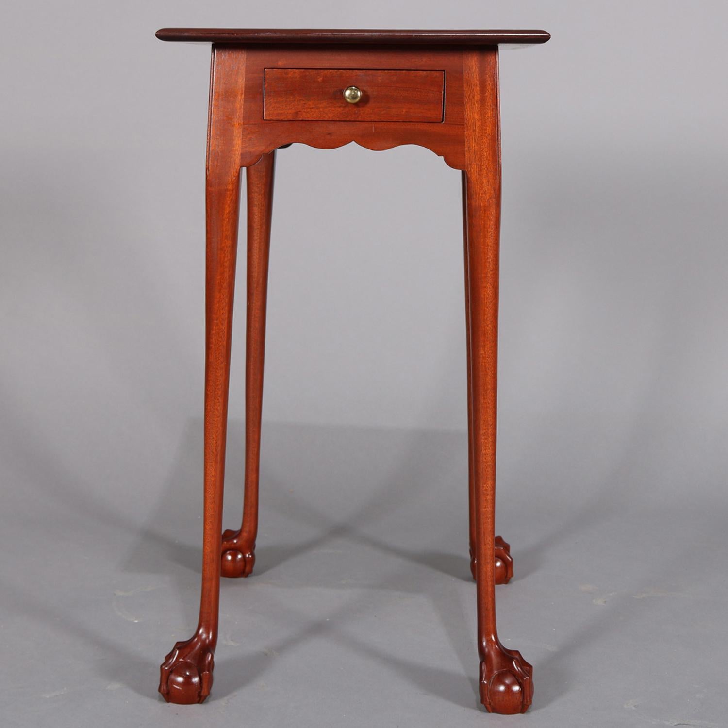 Custom crafted Chippendale school end stand features oversized tabletop over single drawer case with scalloped skirt and seated on cabriole legs with carved claw and ball feet, 20th century.

Measures: 28