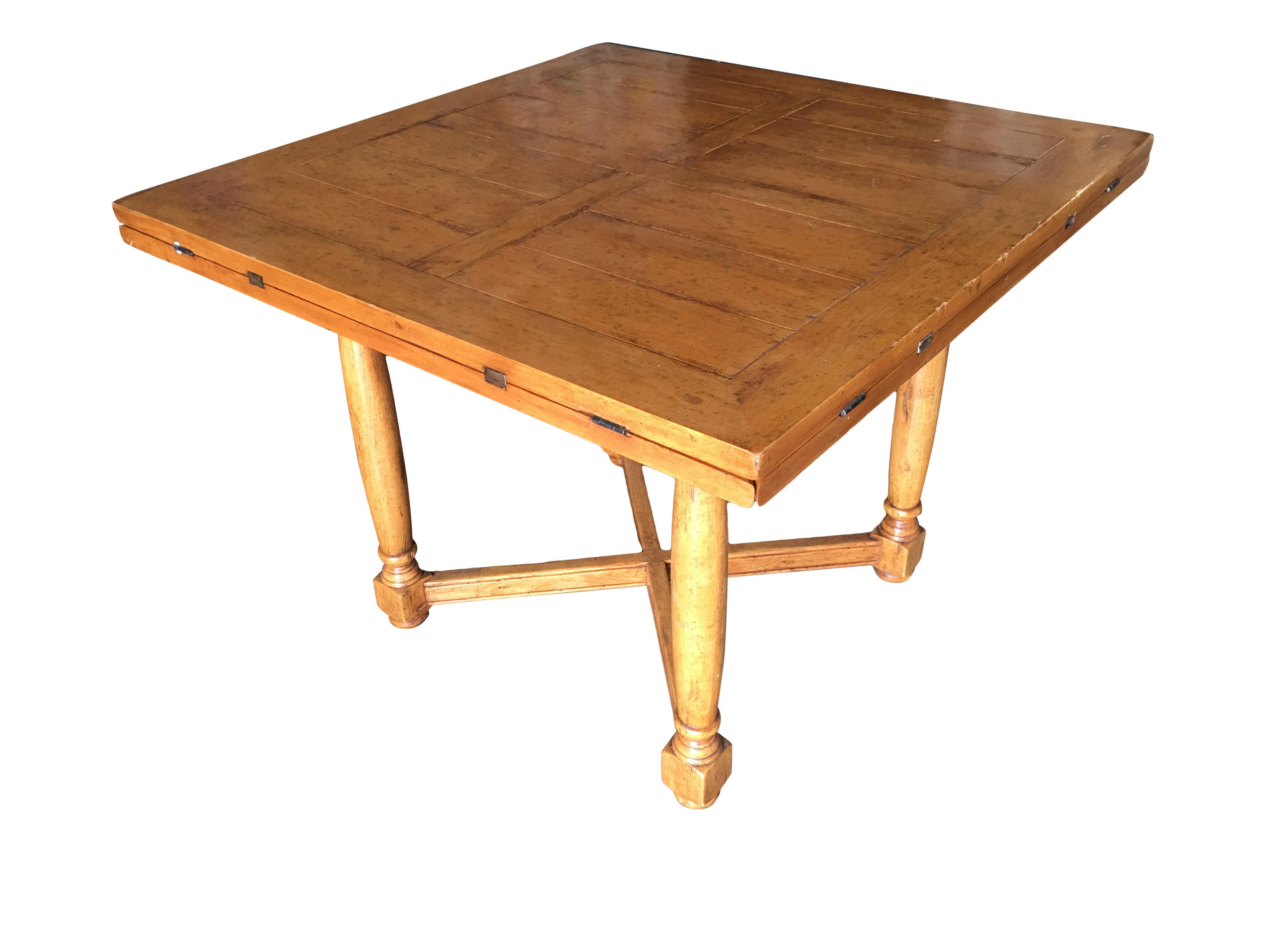 Custom handcrafted oak drop-leaf gate leg dining and a game table featuring a unique design. The table starts off as square four-person dining table with four drop leaves that extend to transform the table into a round gaming table. Each drop leaf