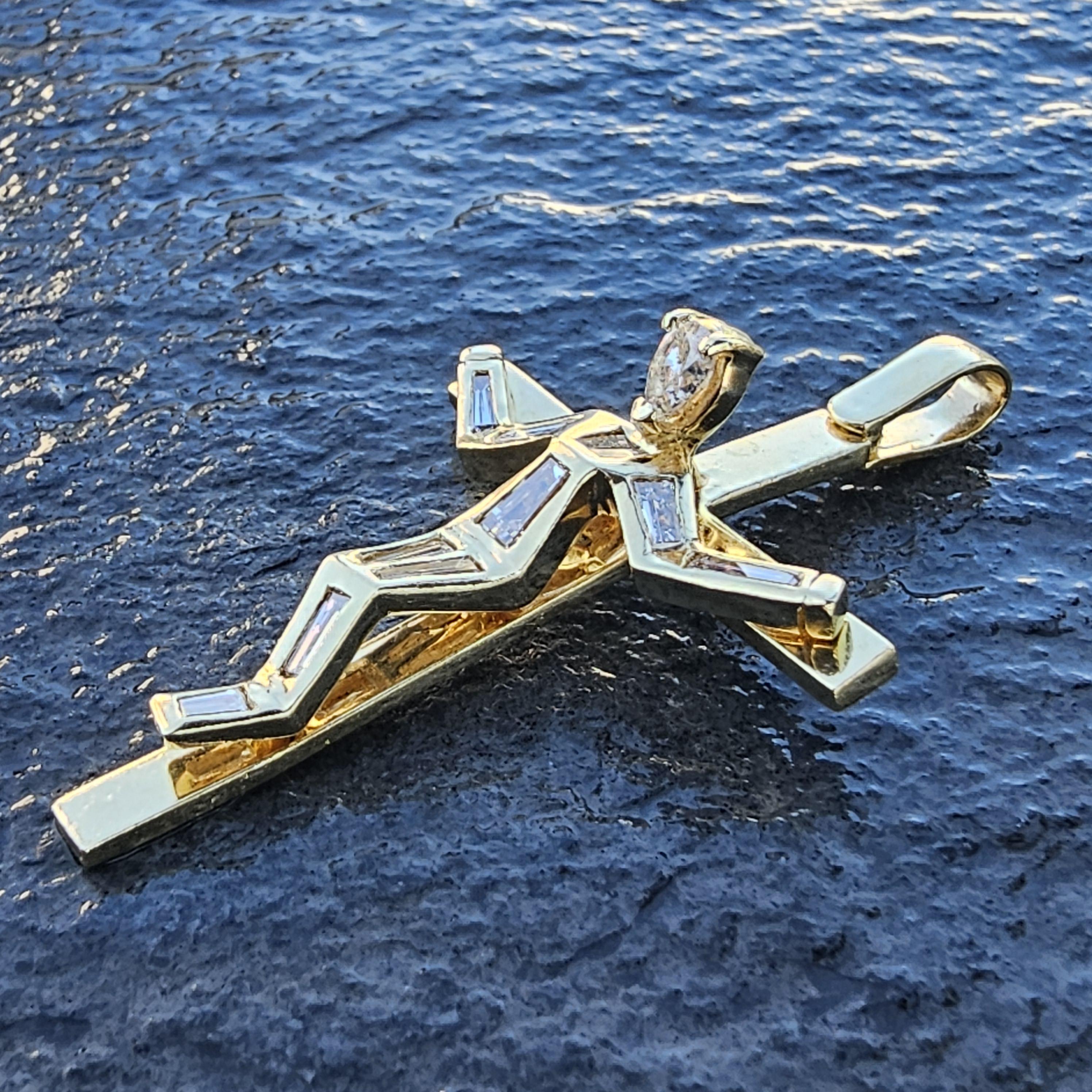 This custom 18k diamond crucifix is a striking piece of fine jewelry crafted in 18k gold. The design features a 3D Jesus with pear-cut white diamond as the focal point, complemented by baguette-cut white diamonds. The intricate arrangement of stones