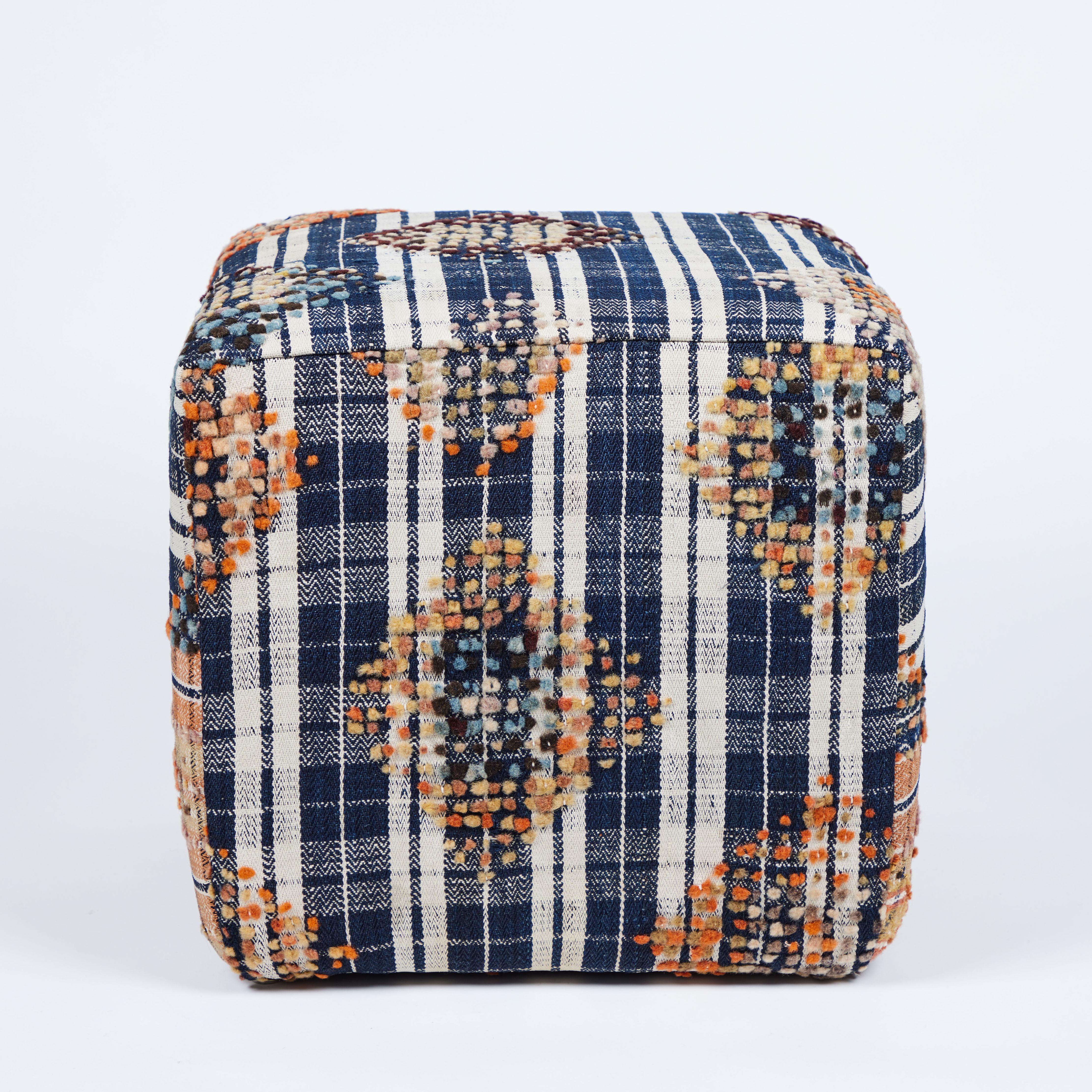 Fantastic custom cubes stools made from a handsome textured graphic black plaid wool rug with touches of pumpkin, saffron, orche and chocolate and complimented by a panel of the same plaid in a burnt orange colorways .


Measures: 18