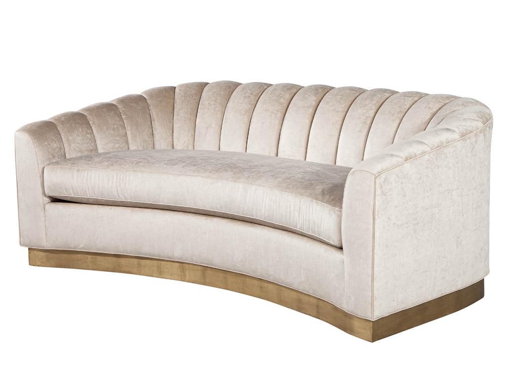 Custom curved channel back sofa by Carrocel. Displayed with a Gold Leafed Platform and luxurious fabric material. Featuring unique channel back design with removable seat cushion. Available in custom finishes and fabrics, pricing will vary.
Sofa