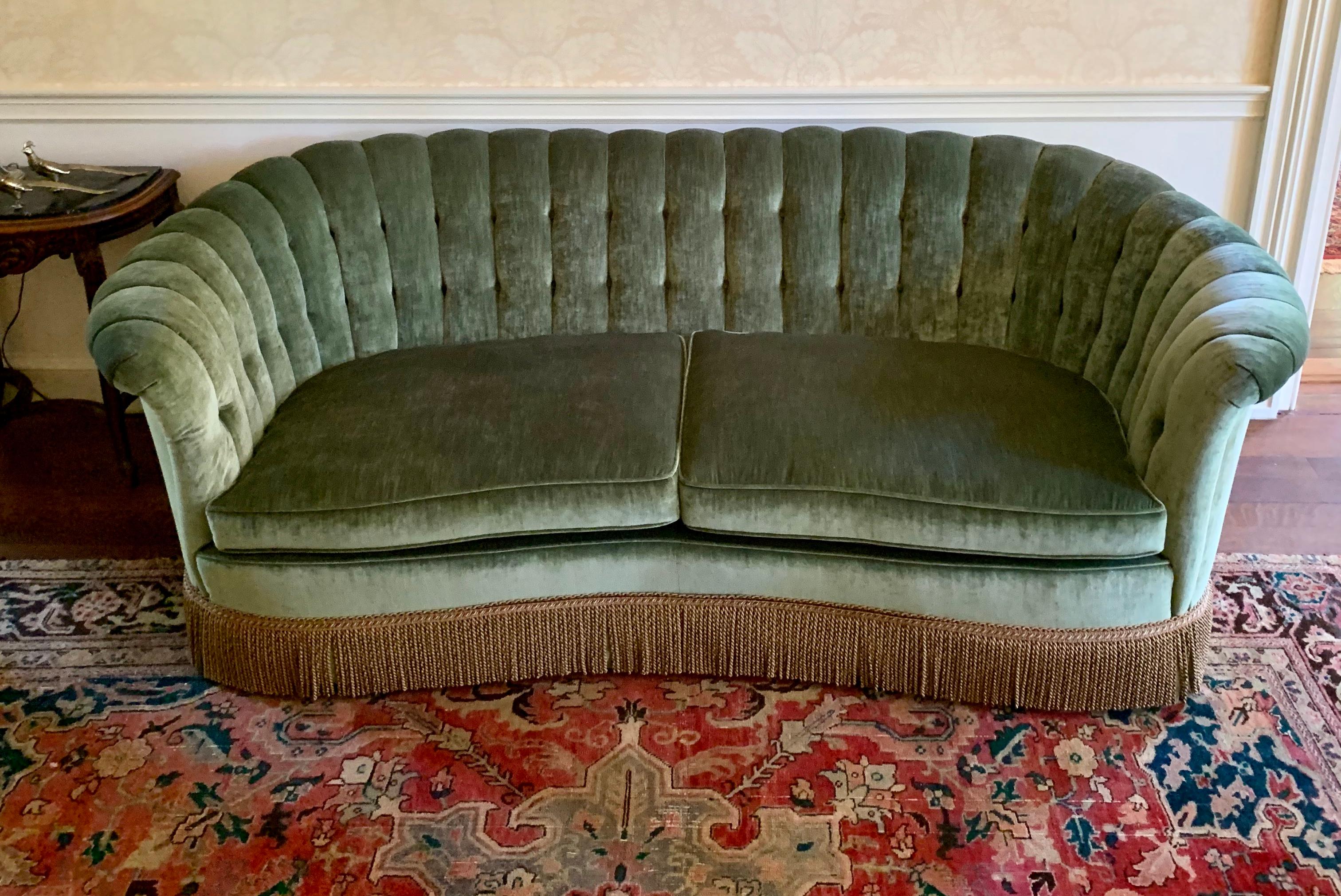 Stunning Art Deco style curved channel back sofa with gorgeous Kravet velvet fabric and tassel fringe. Color is a gorgeous celadon green. Great scale and better lines. Excellent condition and sits beautifully with eight way hand tied construction.