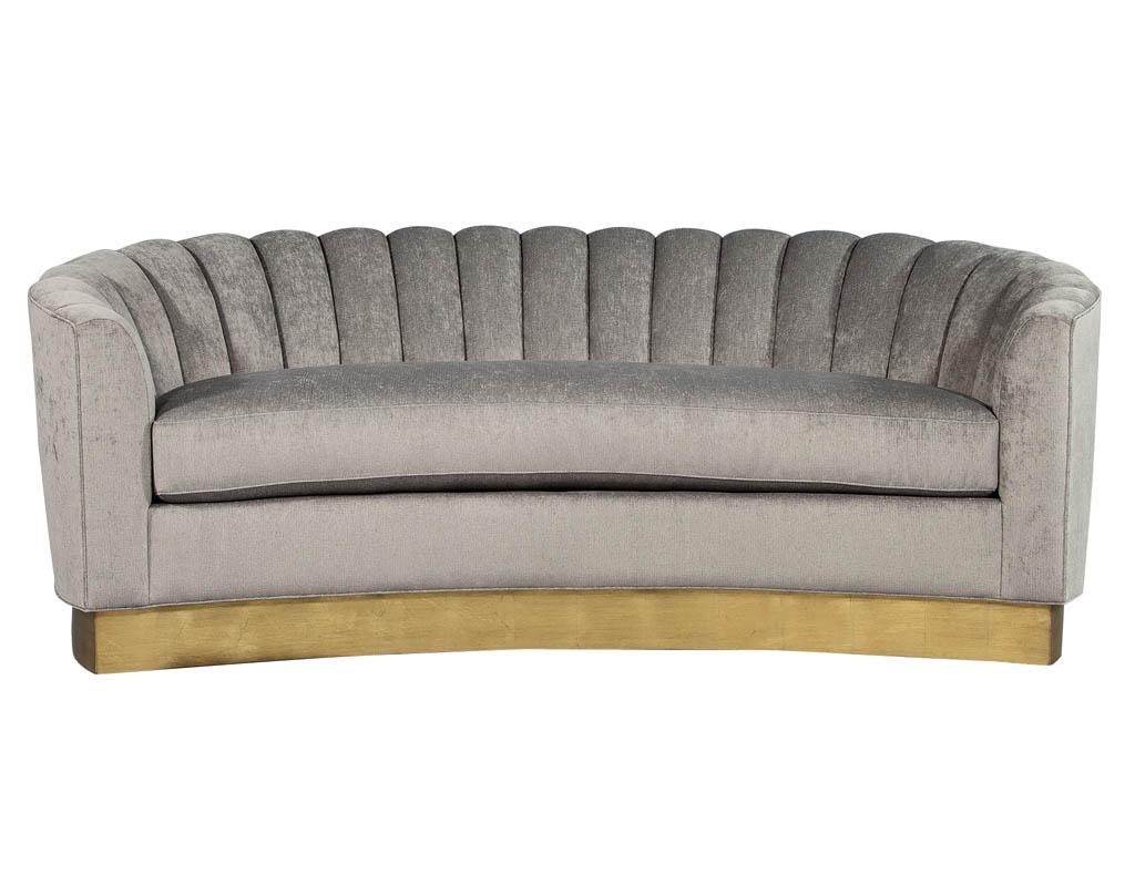 Custom curved channel back sofa with gold leaf base. Custom made here at Carrocel, featuring a contoured channel back. Sitting on a beautiful gold leafed platform base.

 