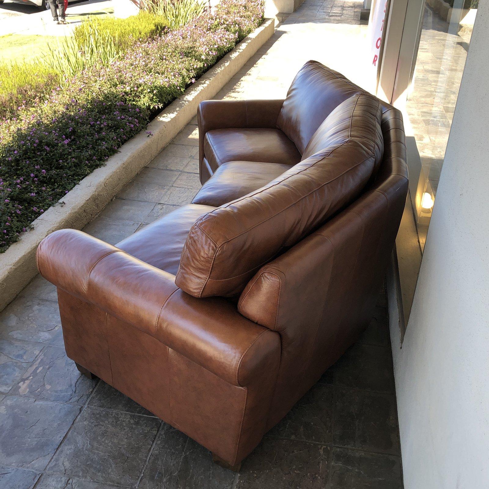 Custom sofa by Omnia Leather. Featuring a curved silhouette, to induce conversation, this Classic sofa invites comfort with loose back foam cushions, down wrapped seat cushions and gentle rolled arms. Southwest Pecan brown leather.

Original price