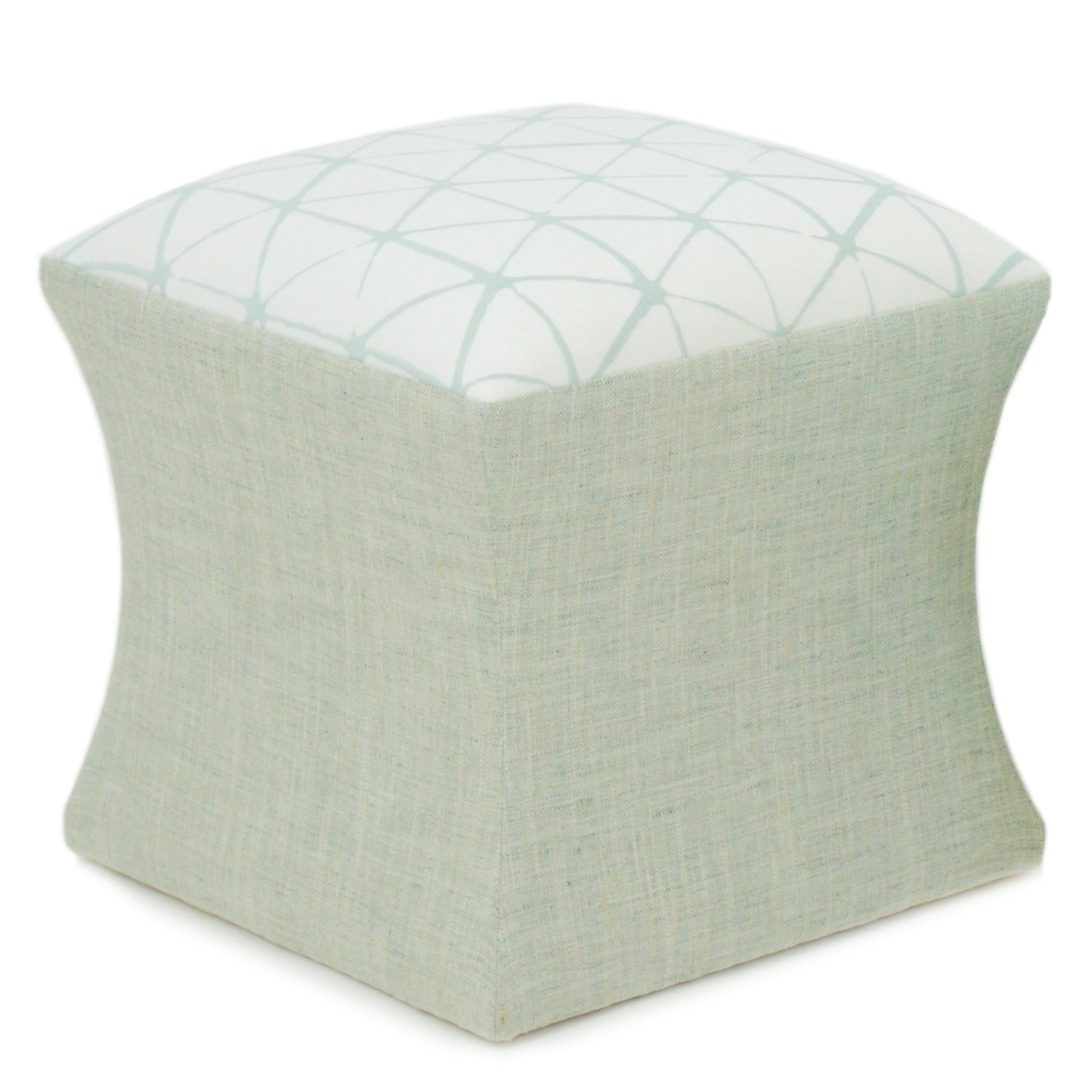 Hour glass shaped small ottoman. Built in solid hard maple topped with a cotton/dacron wrapped foam making it firm, yet comfortable. Piece shown is covered in a lightweight embroidered linen viscose blend with a hexagonal pattern with a hand-drawn