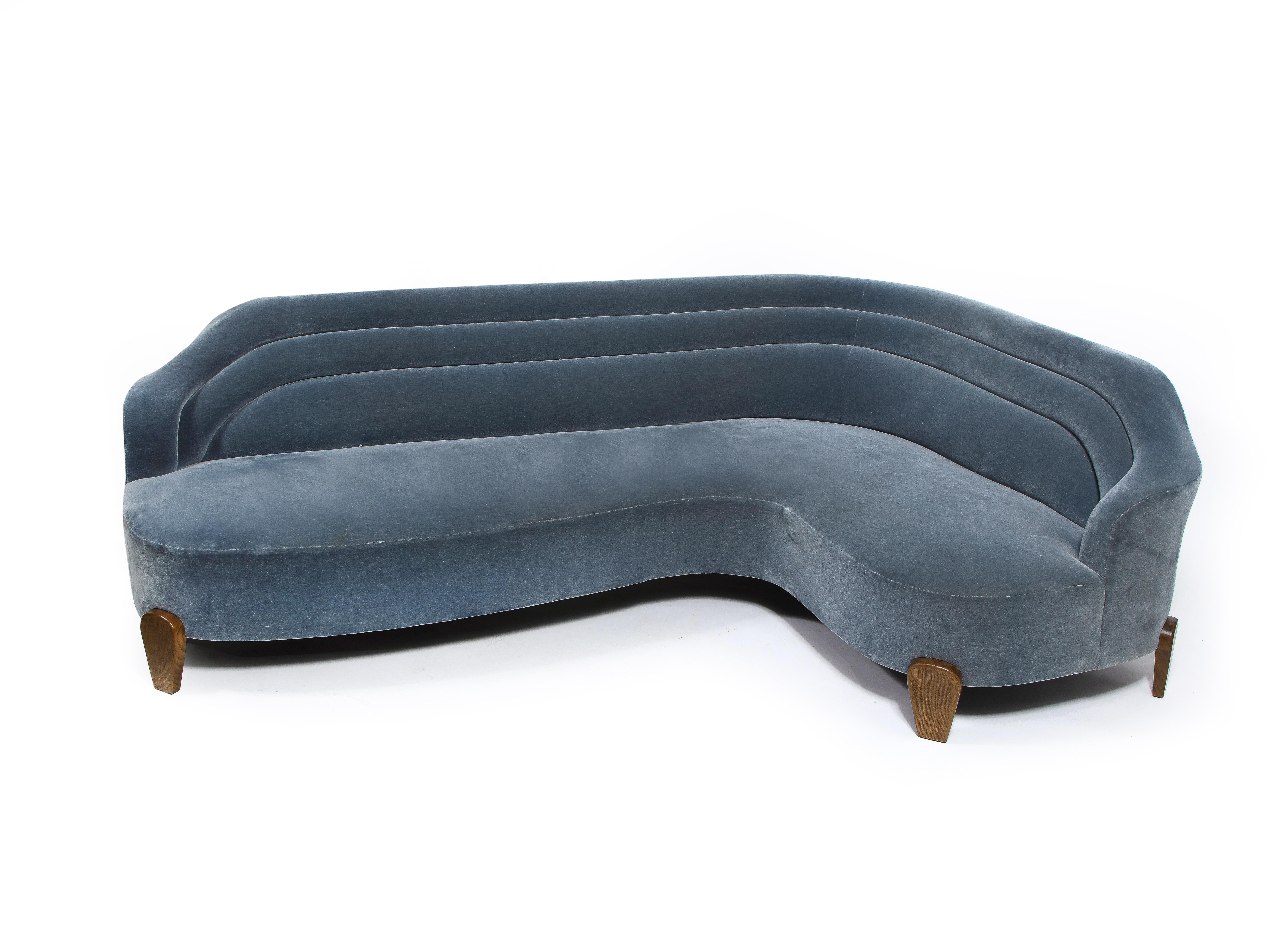 Original design by Charlie Ferrer. Inspired by the serpentine sofa forms of Kagan. Extremely comfortable.

Sofa construction in very good condition. Fabric on two panels of upholstery damaged and need to be recovered. Offered in as-is condition. 