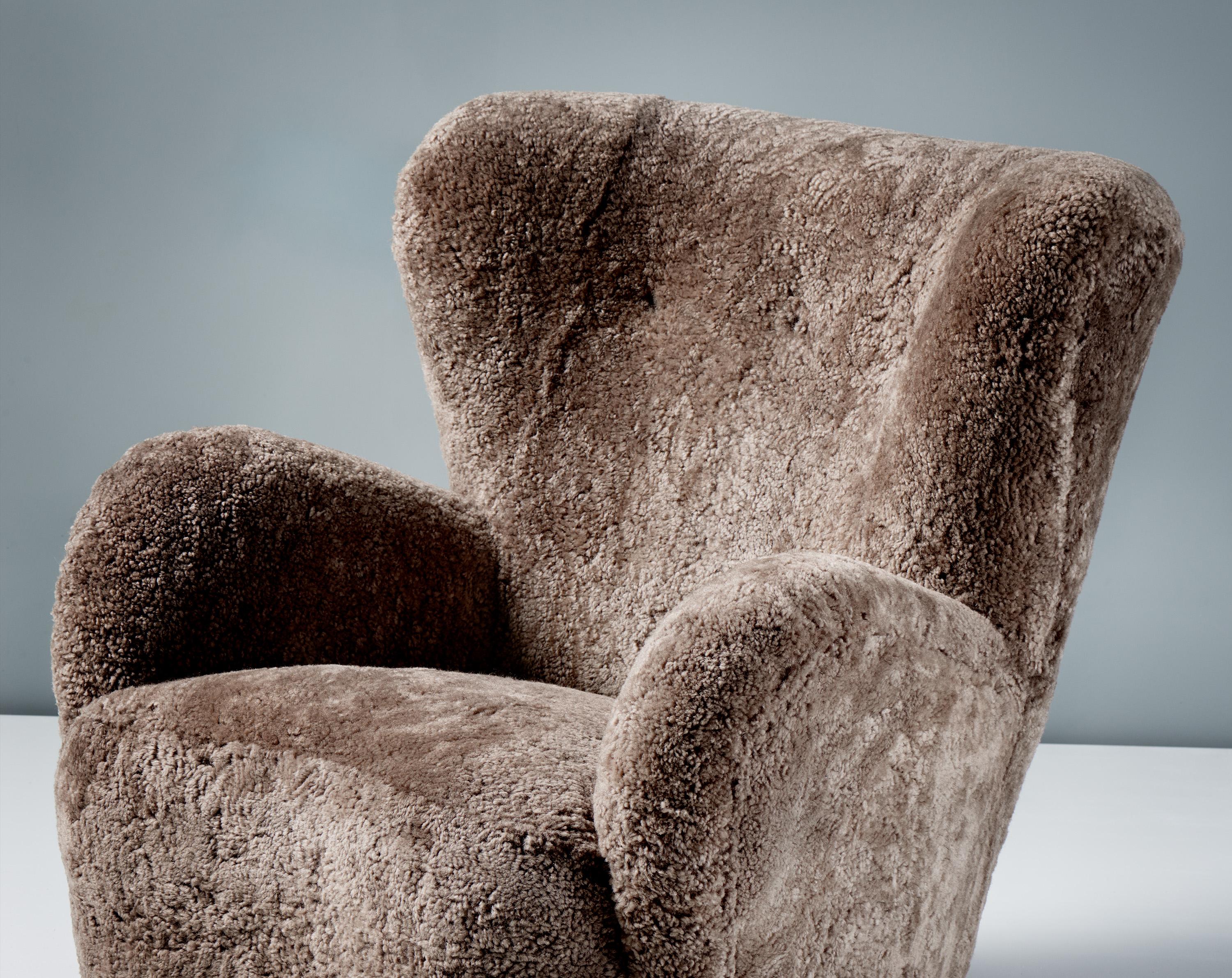 Custom Danish Cabinetmaker Lounge Chair in COM for Bre

This large lounge chair produced by a Danish Cabinetmaker in the 1940s is typical of Danish lounge chair designs of the day. It features large, curved arms and low, wide, refinished stained
