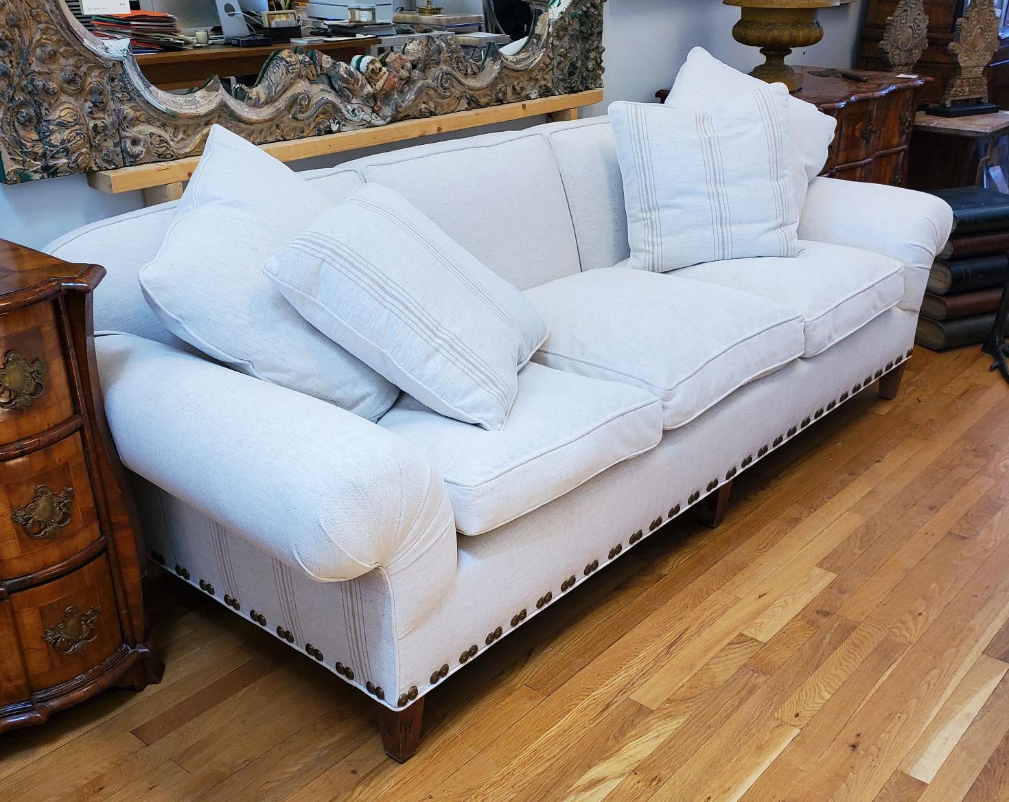 Custom Designed Georgian Style Sofa with White Crypton Upholstery. Rolled arms with loose back and seat “Down/Feather” cushions. Remarkably comfortable. Recently upholstered in Crypton fabric with decorative nailhead trim. 20th Century. Measures: