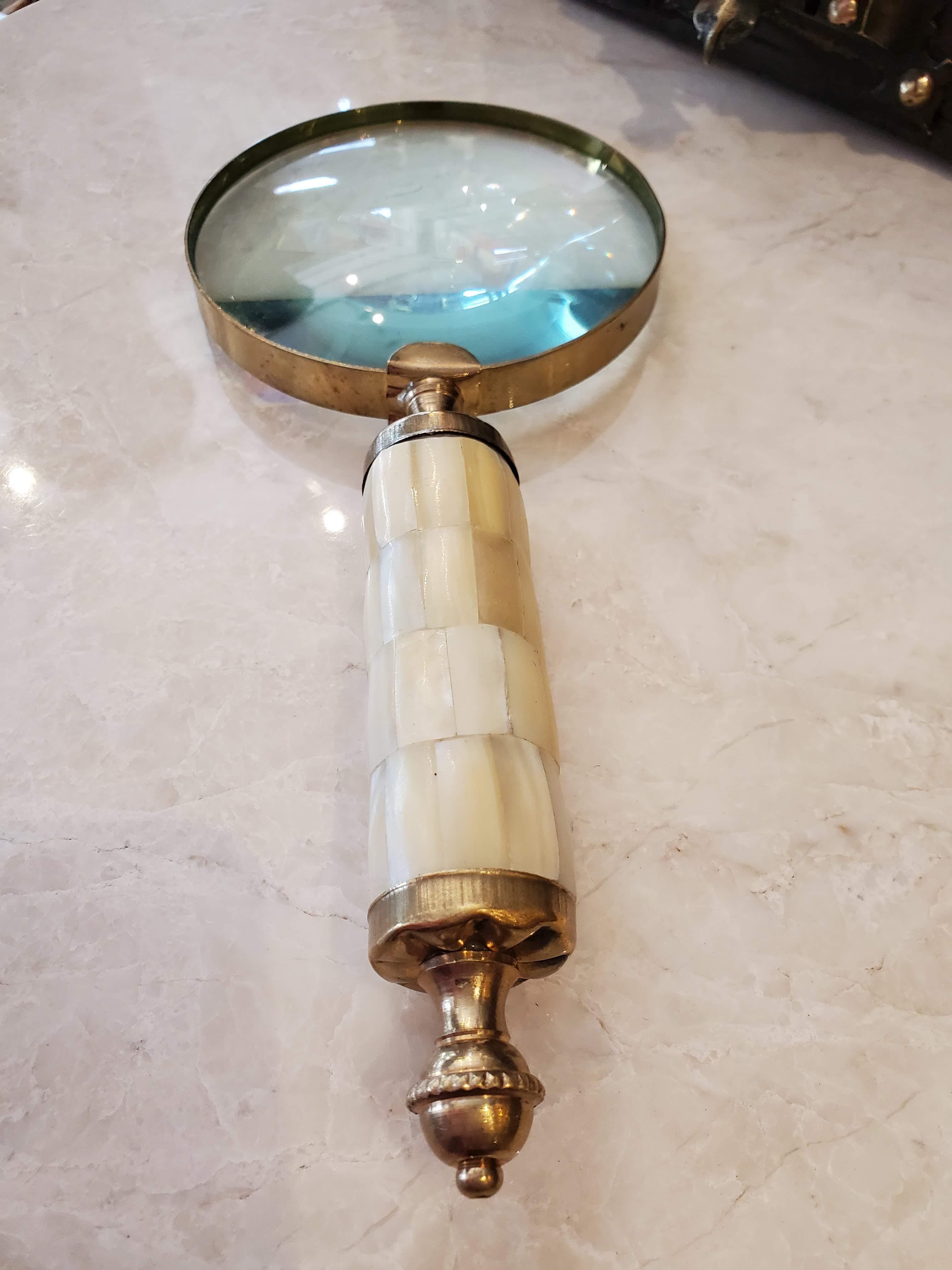 Need to do a little sleuthing or just see something a little more clear, this custom designed magnifying glass made with a 19th century mother of pearl and brass English handle, will help do the job.

Made in England. 

Measures: 9.25
