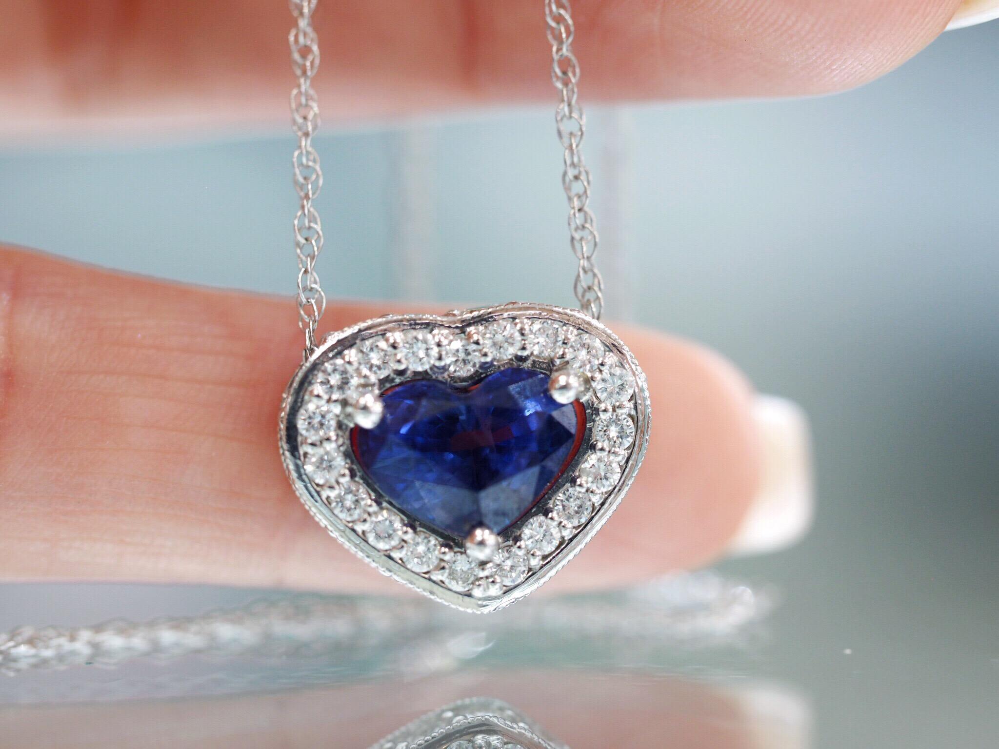 Stunning 1.89CT natural blue sapphire heart is set in a custom made diamond halo pendant. The Diamonds surround the center in a beautiful halo, also flowing on the outer side facing outwards giving the maximum brilliance at every angle. The pendant