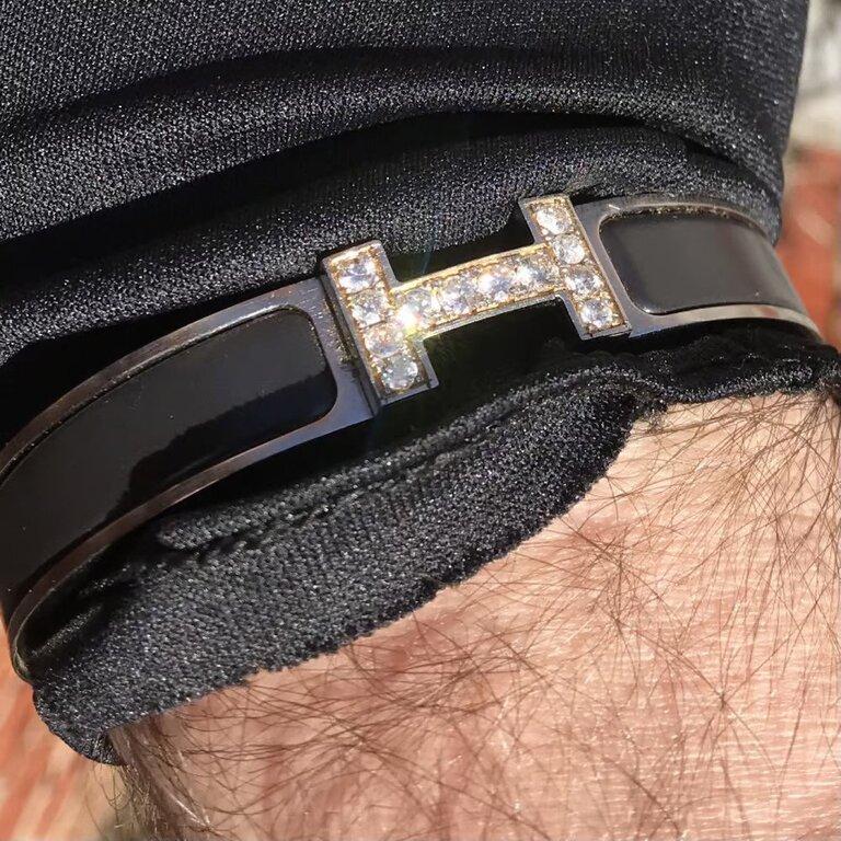 Custom Diamond Hermes Clic H Enamel Bracelet complete with original box.

An original Hermes Clic H bracelet GM size in black and silver color is customized hand-set with approx. 1.25 carats of natural genuine earth-mined SI Diamonds. The diamonds