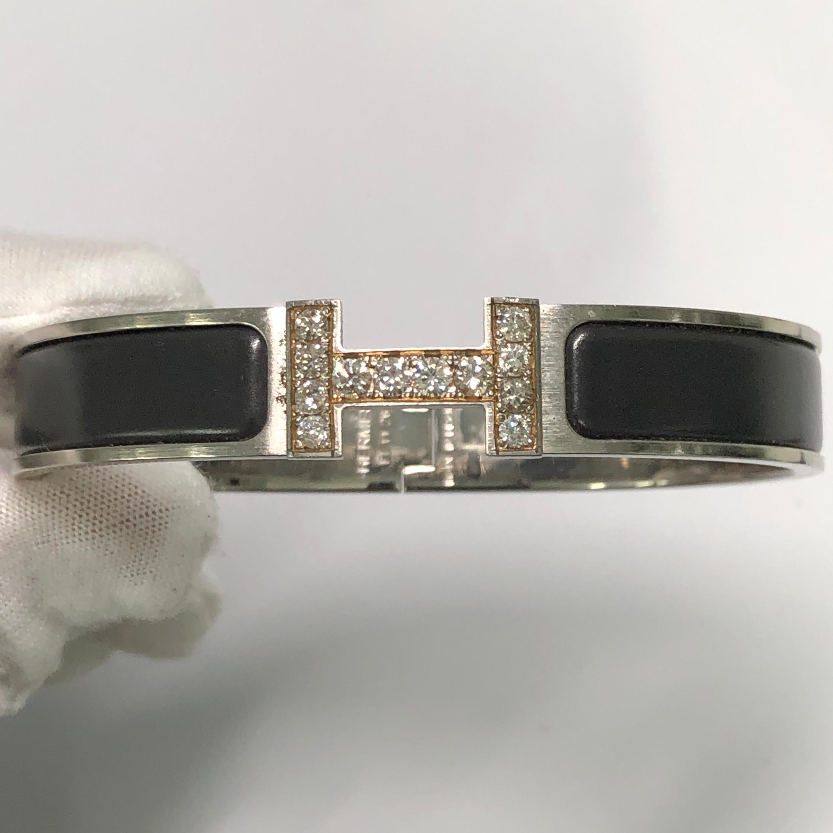 Custom Diamond Hermes Clic H Enamel Bracelet GM size complete with original box.

An original Hermes Clic H bracelet in black and silver color is customized hand-set with approx. 1.25 carats of natural genuine earth-mined SI Diamonds. The diamonds