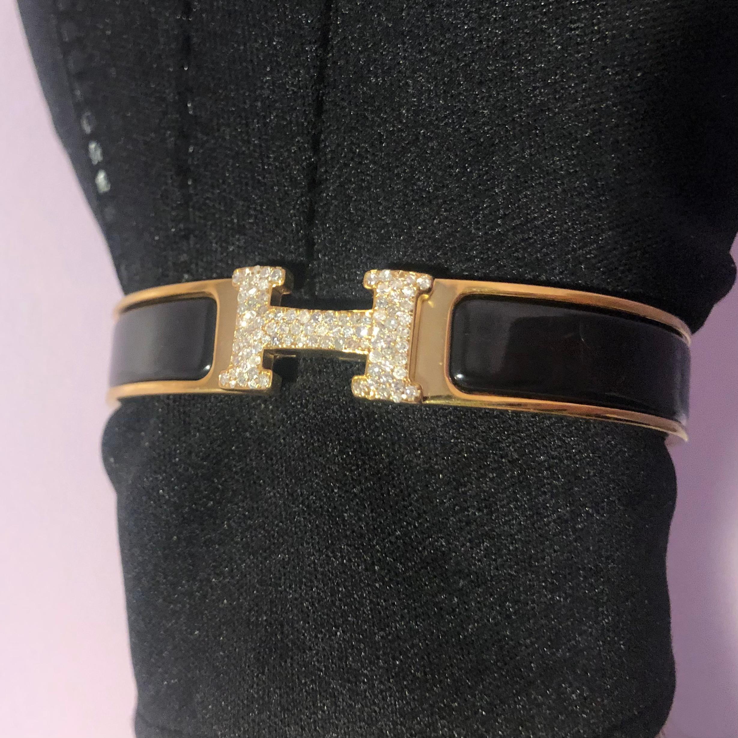 Custom Diamond Hermes Clic H Bracelet complete with original box and booklet papers. 

An original Hermes Clic H bracelet GM size in Black and Gold color is customized hand-set with approx. 1.00 carats of natural genuine earth-mined SI-I Diamonds.