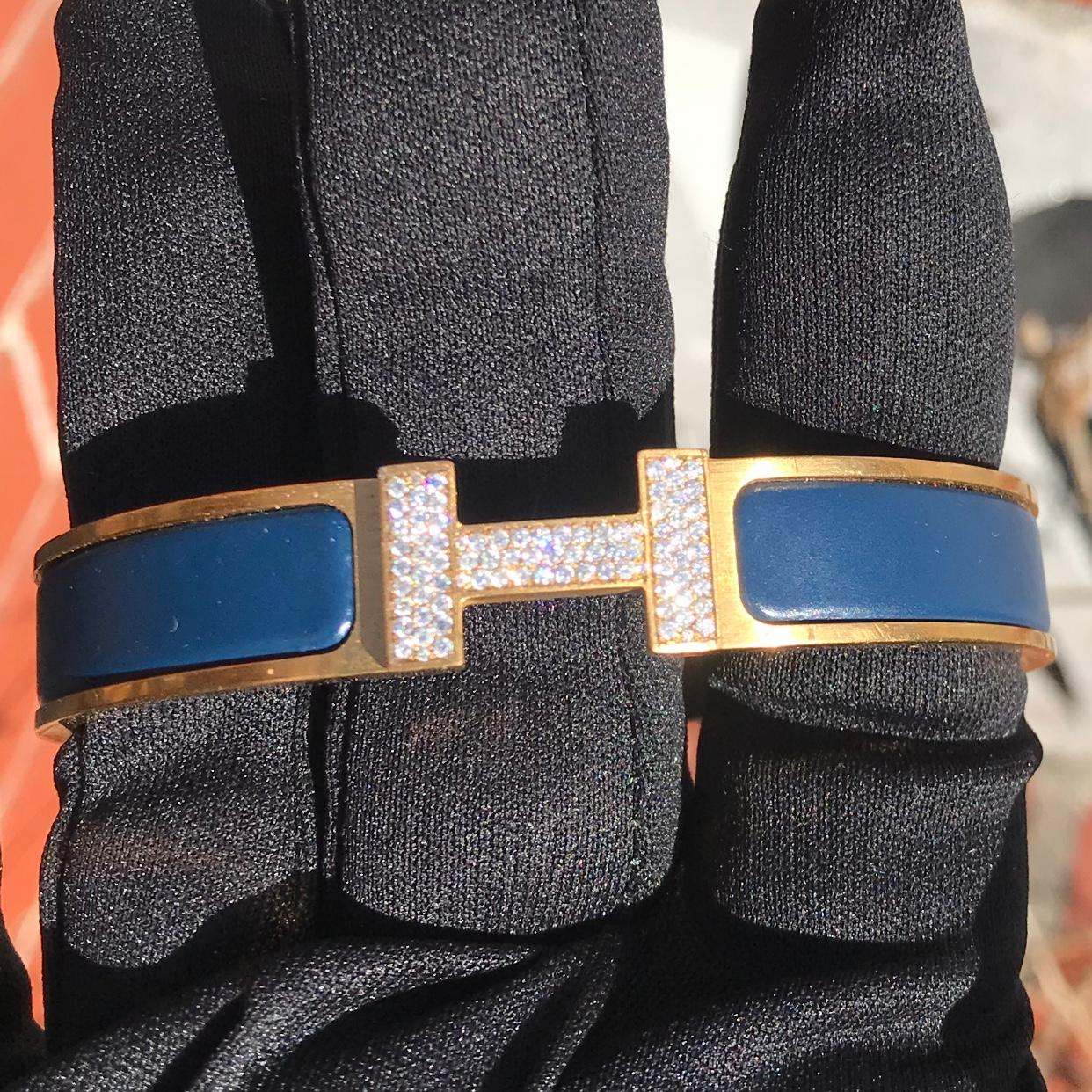 Custom Diamond Hermes Clic H Bracelet complete with original box.

An original Hermes Clic H bracelet GM size in blue and gold color is customized hand-set with approx. 1.25 carats of natural genuine earth-mined VS-SI Diamonds. The diamonds shine