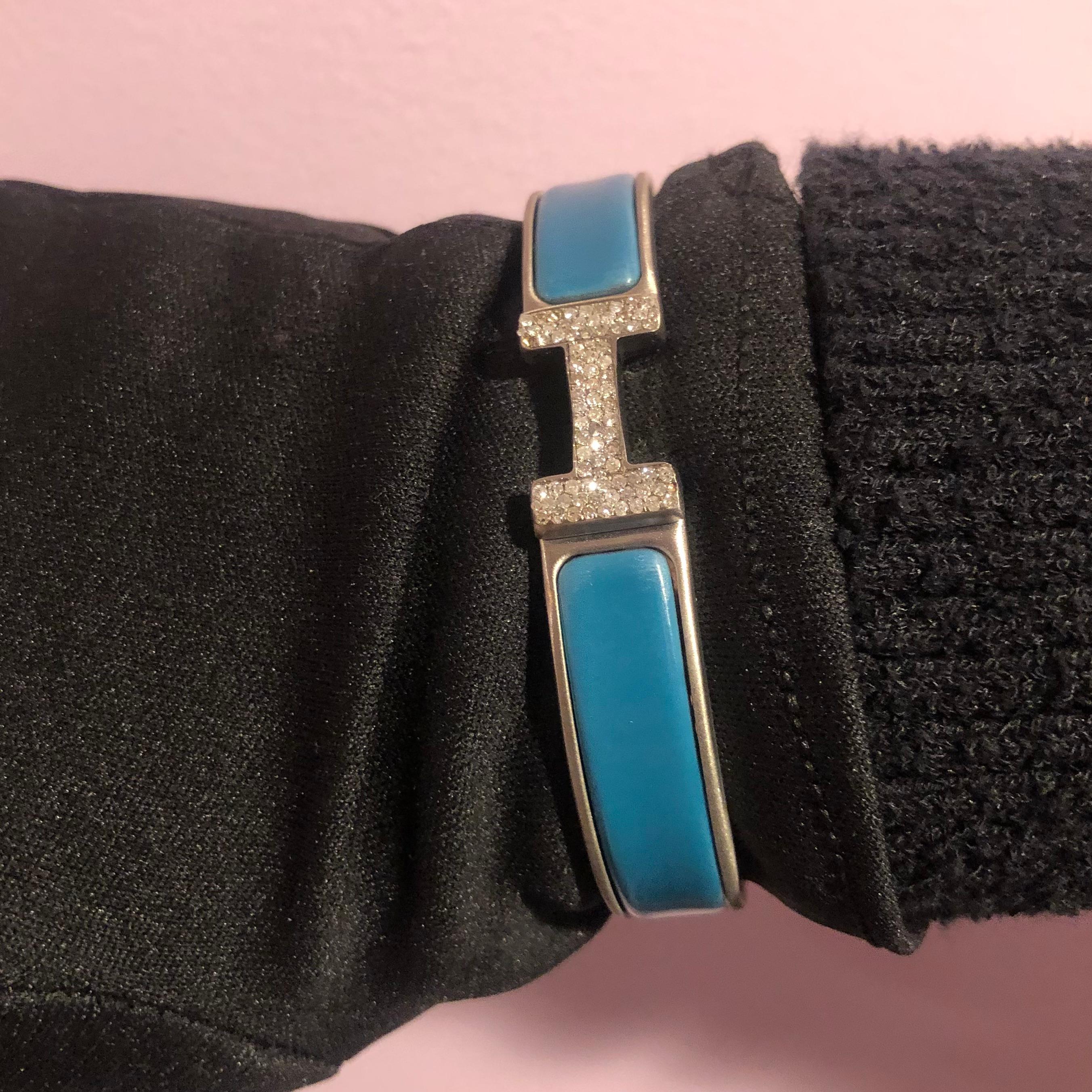 Custom Diamond Hermes Clic H Bracelet complete with original box.

An original Hermes Clic H bracelet GM size in Blue and Silver color is customized hand-set with approx. 1.25 carats of natural genuine earth-mined SI-I Diamonds. The diamonds shine