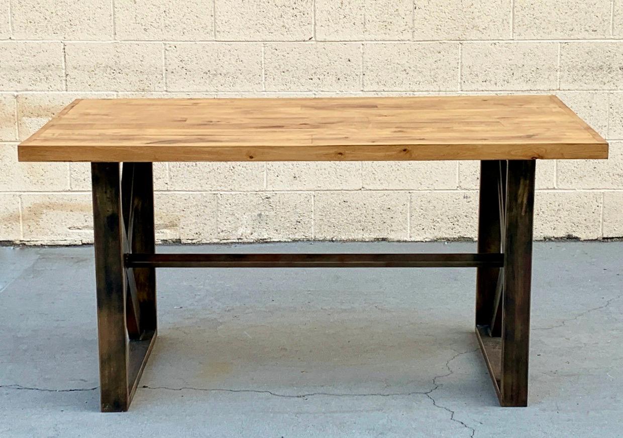 Our custom made steel and wood table is perfect for dinning, work or retail display. Incredibly sturdy with a high weight capacity, this table is elegant and versatile. Composed of 1” x 3” steel tube frame with 3” steel c-channel cross braces on