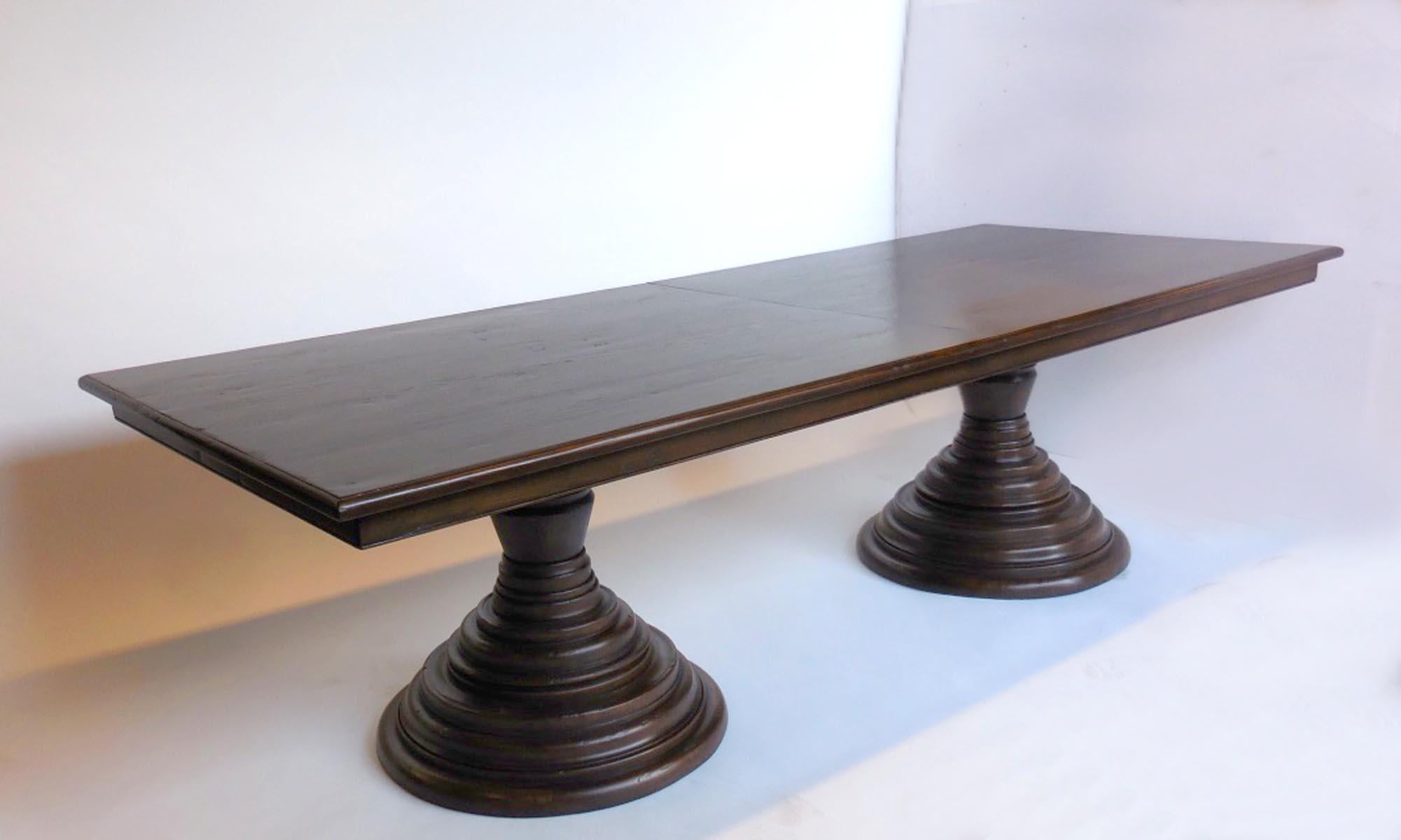 Custom table with double beehive pedestals. This table can be made with or without leaves in any size. As shown in Walnut with a custom finish, medium distress. Price reflects size as shown, 108 inches with two 16 inch leaves, making it 144 inches