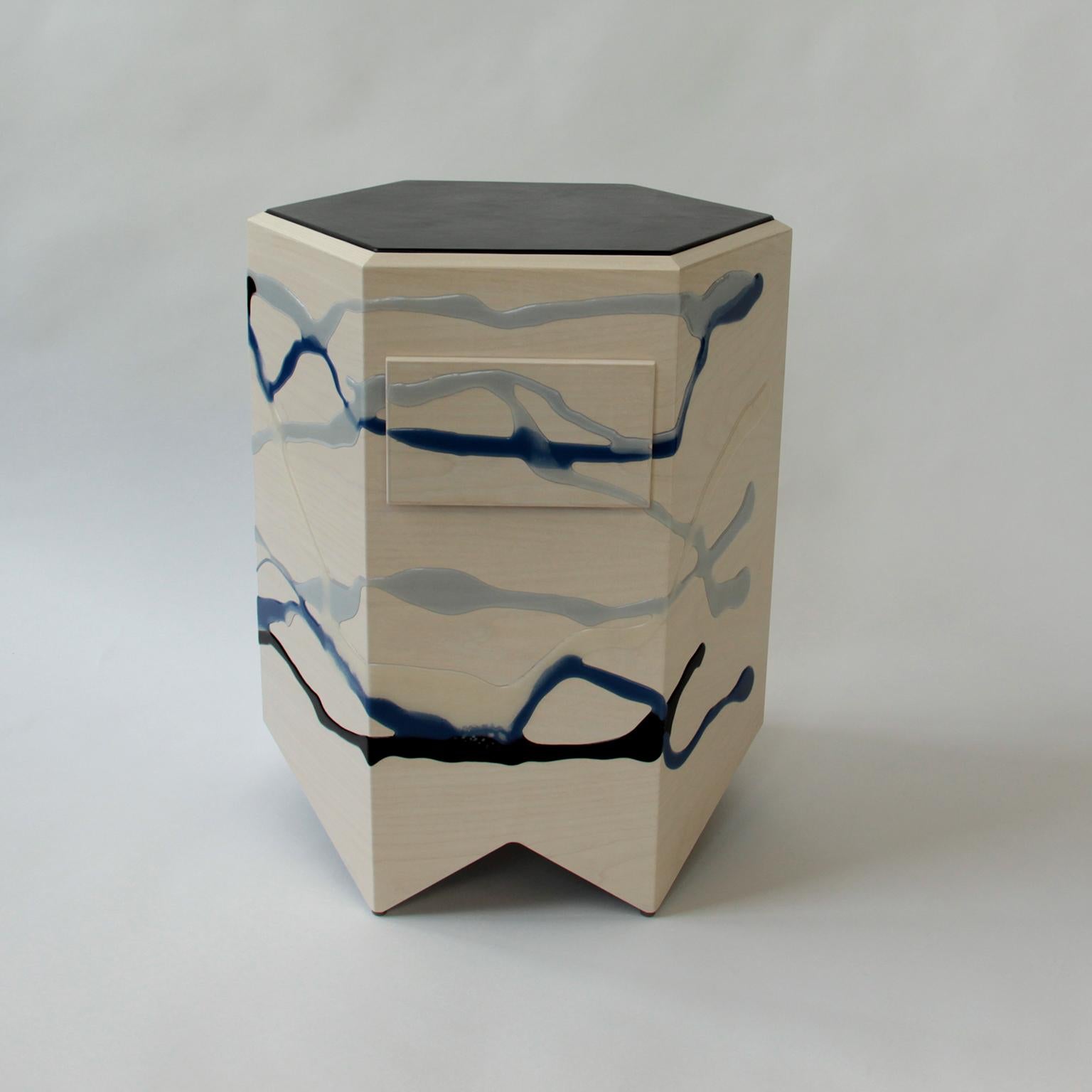 The Drip/Fold Nightstand by Noble Goods is constructed of a single sheet of ash plywood that has been hand-dripped with liquid resin, then bent into a hexagonal shape. Finished with a leather top.

Drawer measures 8