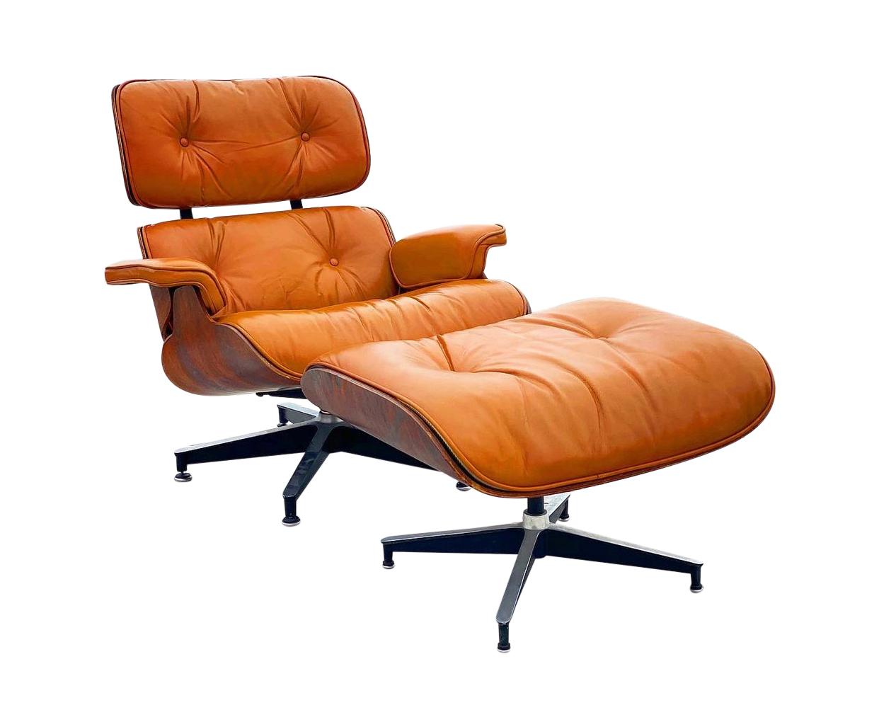Beautiful custom edition of the iconic Eames lounge chair and ottoman. Rosewood shells and aluminum bases cradle the custom burnt orange leather cushions. New leather very soft and in excellent condition. This color is supremely rare. Chair signed