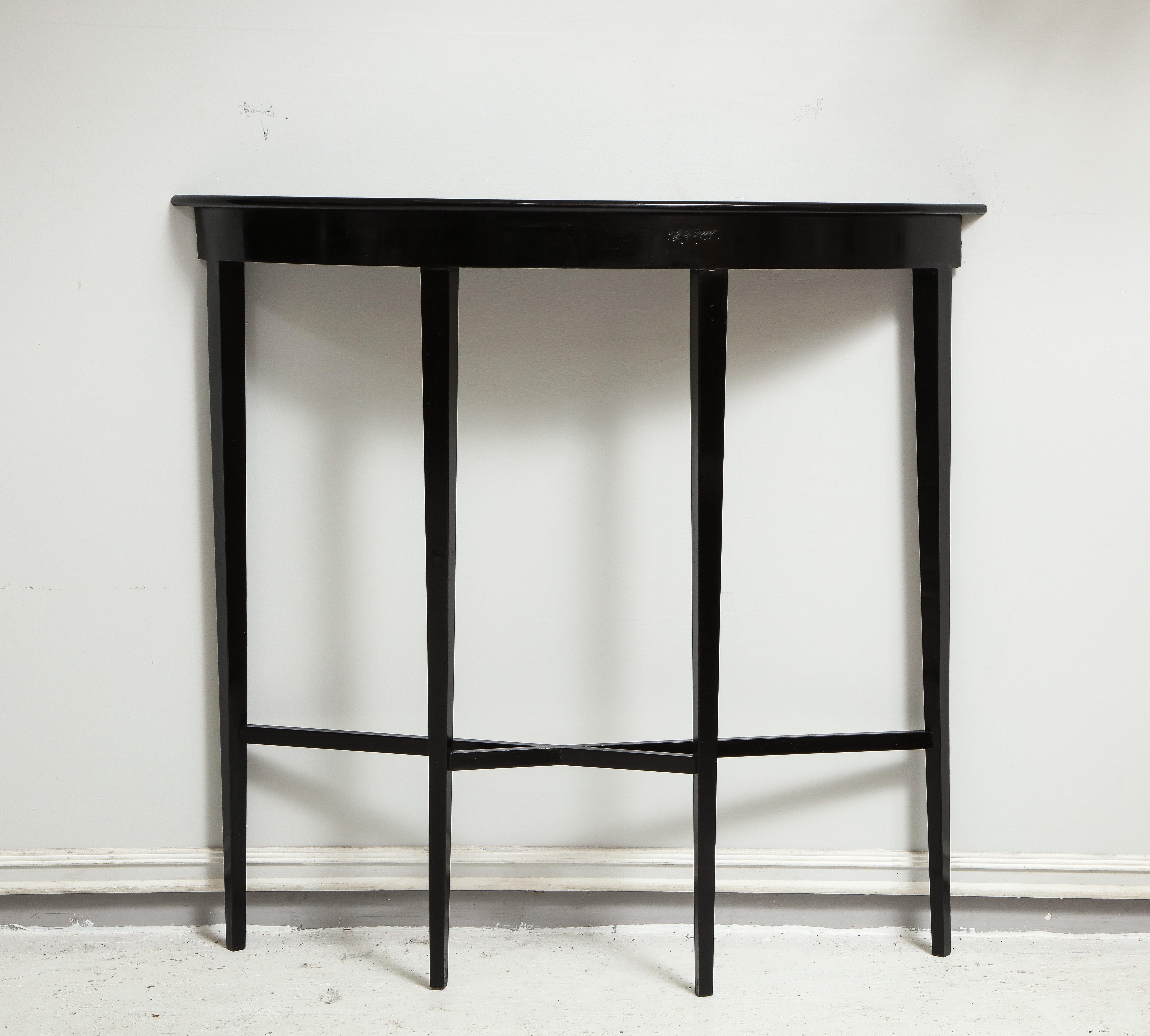 Custom ebonized demilune console on tapered legs.
Please note the lead time for custom made is 8-10 weeks.