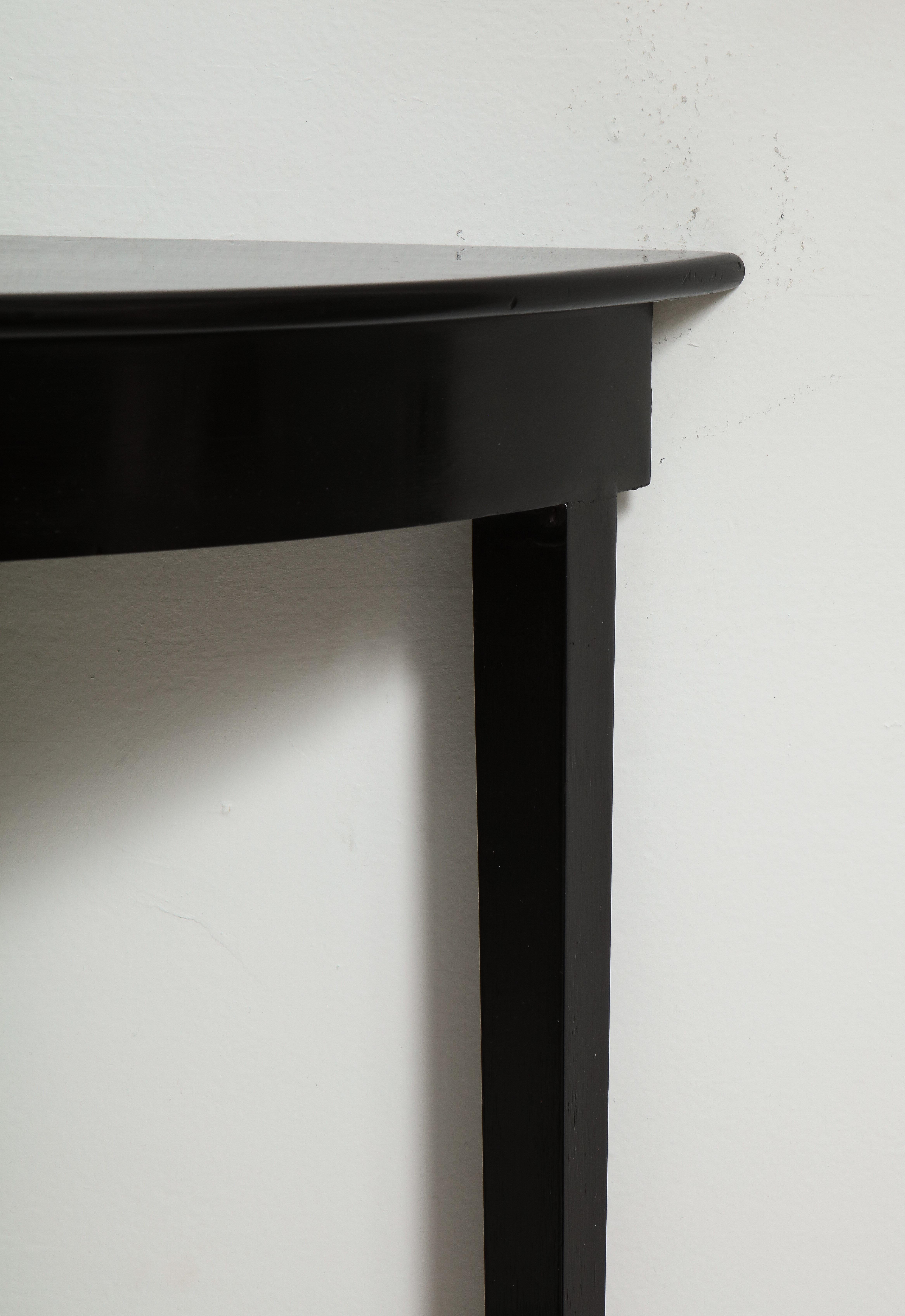 Contemporary Custom ebonized demilune console on tapered legs For Sale