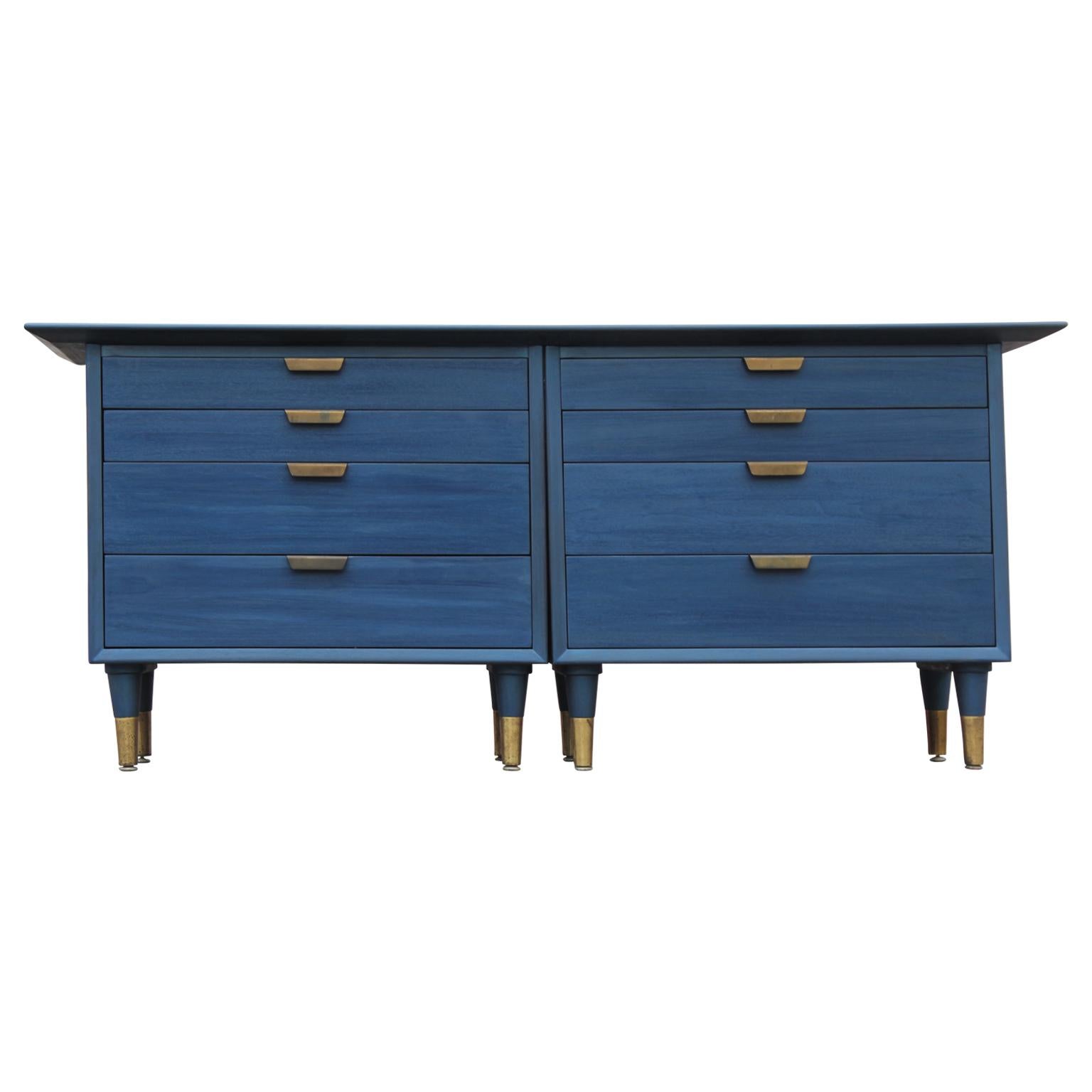 Stunning modern blue chest or dresser. It has been restored with a blue aniline finish. It has 8 drawers with flared brass handles. Underneath there are 8 tapered legs with brass caps.