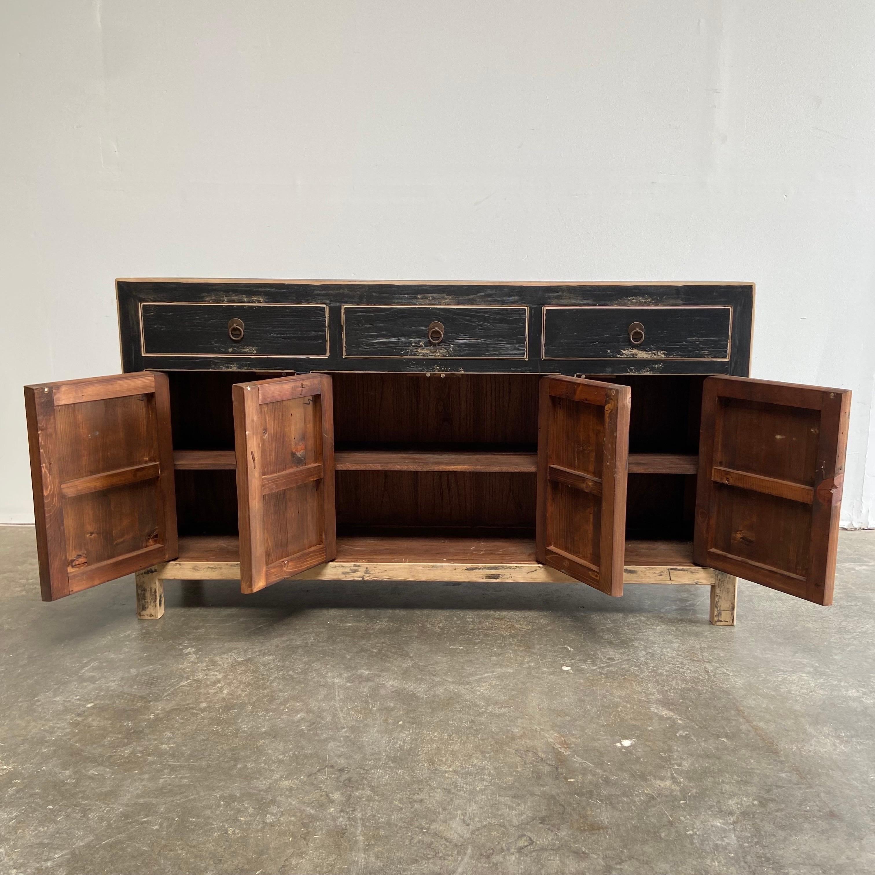 Vintage reclaimed elm wood 4 door, 3 drawer black distressed painted console. Perfect for an entry, use as a bar, in a dining room, or as a tv console. 
Doors open up with ease.
Size: 63”w x 16”d x 36”h.