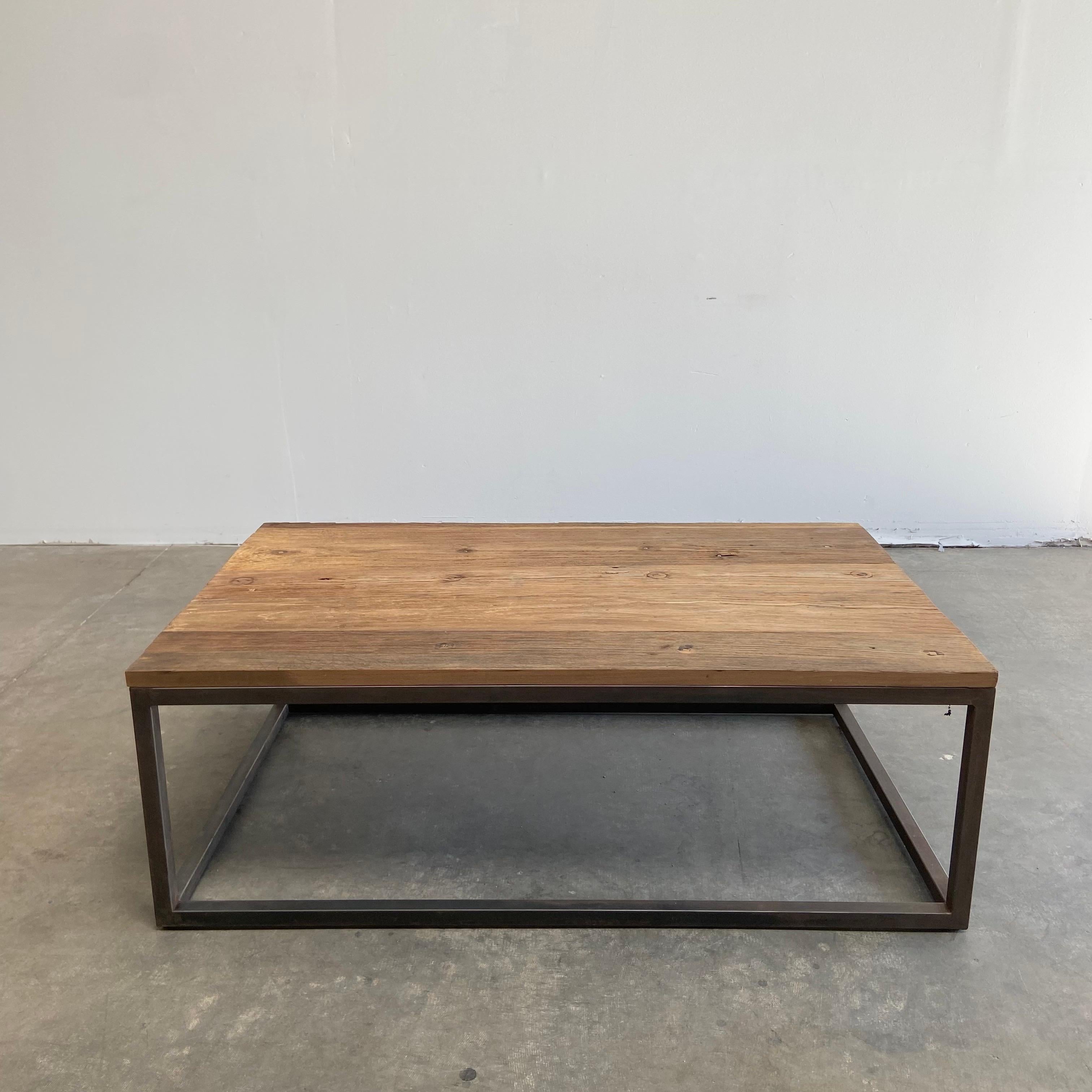 Custom elm wood brick makers coffee table iron and wood
Size: 52” W x 32” D x 18” H
Reclaimed elm wood top with natural markings, solid iron base with antique distressed patina.

