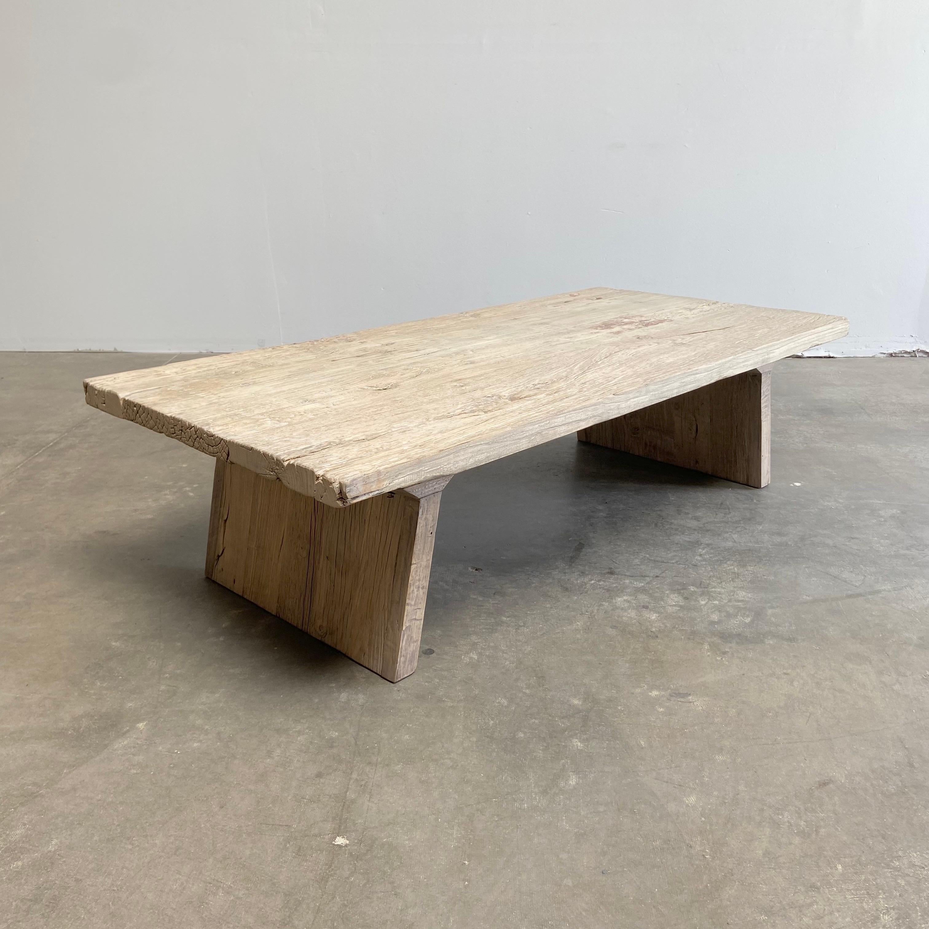 Custom Made Elm coffee table 67”W x 31-3/4”D x 18”H
This custom elm table is made from solid thick elm wood planks.
The base has slanted legs, in a sleek modern design.
 