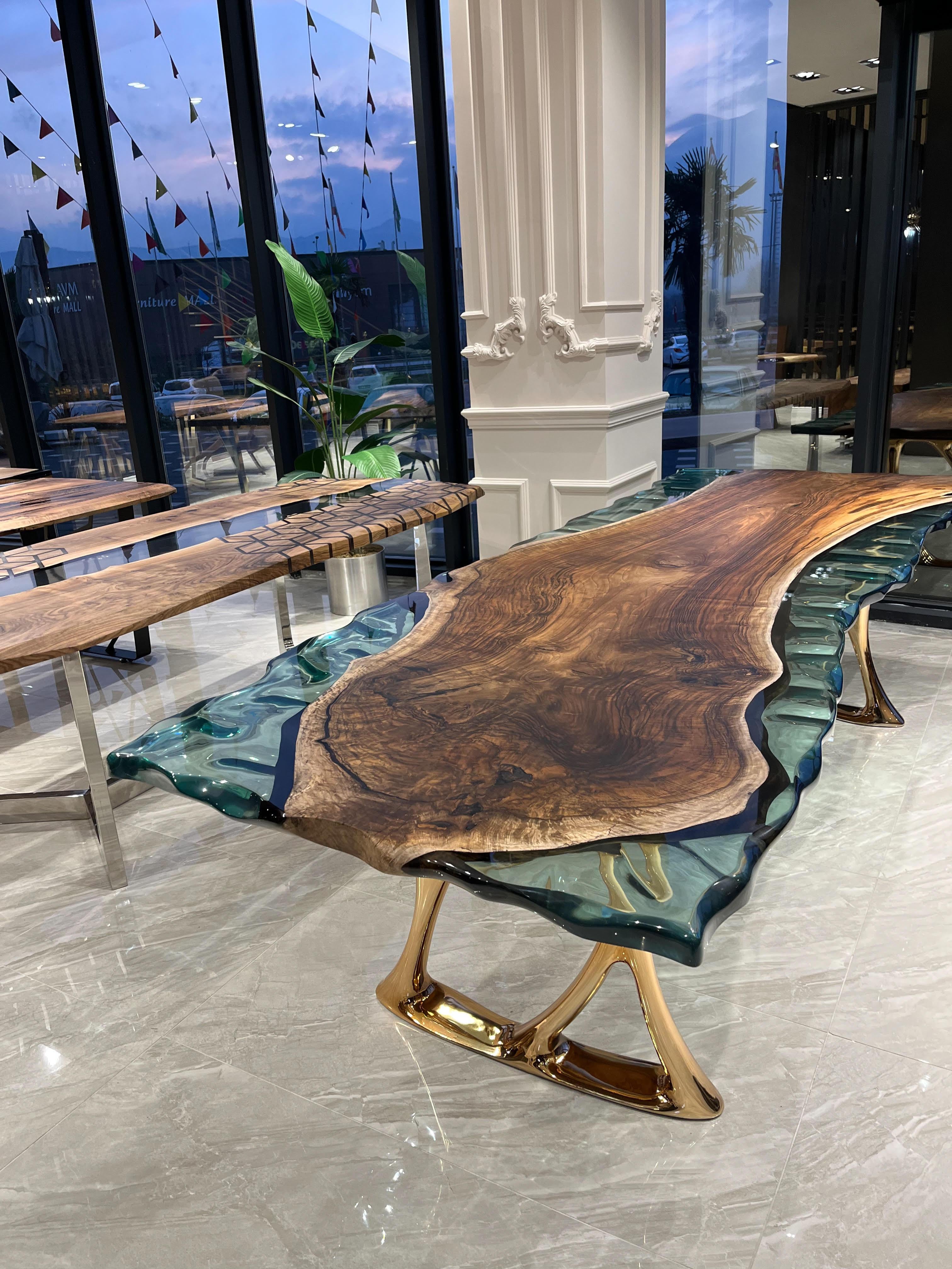 Live Edge Epoxy Resin Table

Would you like to have a great looking table with a sea green tone?
We brought together one of the wonderful colors of nature with the unique structure of the walnut woods.

This table is made of 500 years old ancient