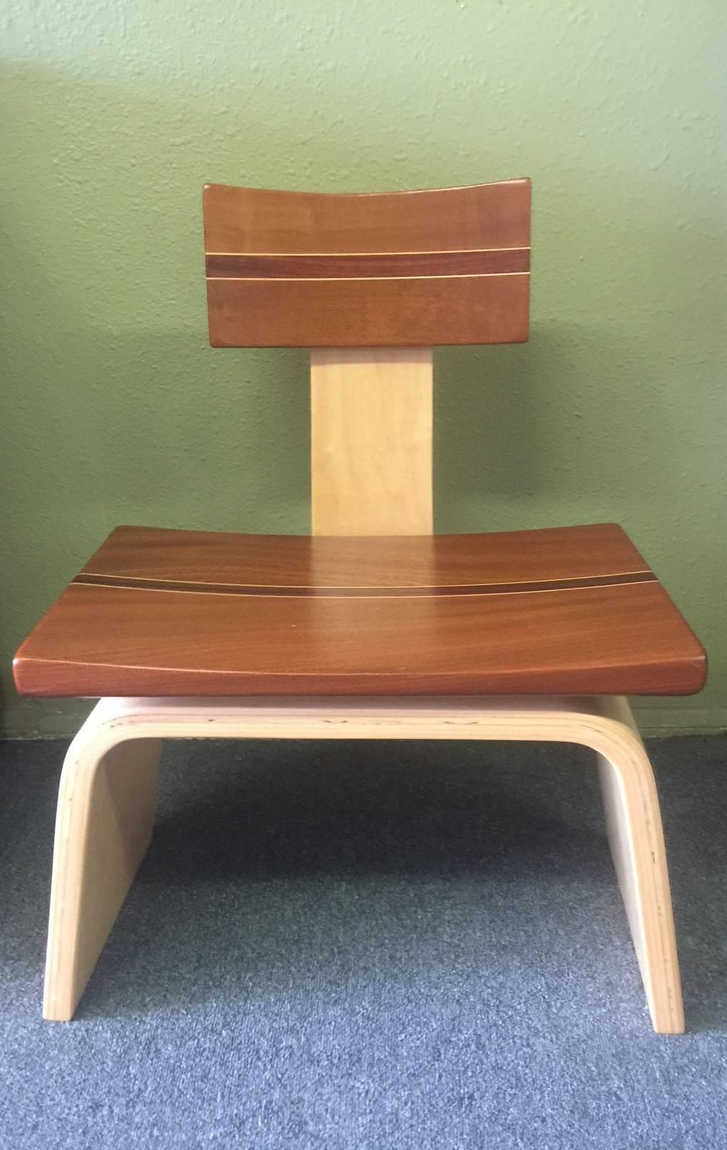 Custom hardwood game chair by California furniture make David Levy, circa 2000s. The chair has a sculpted saddle seat made of exotic and domestic hardwoods. The base is made of solid veneers of maple and formed into a curve. The saddle seat is made
