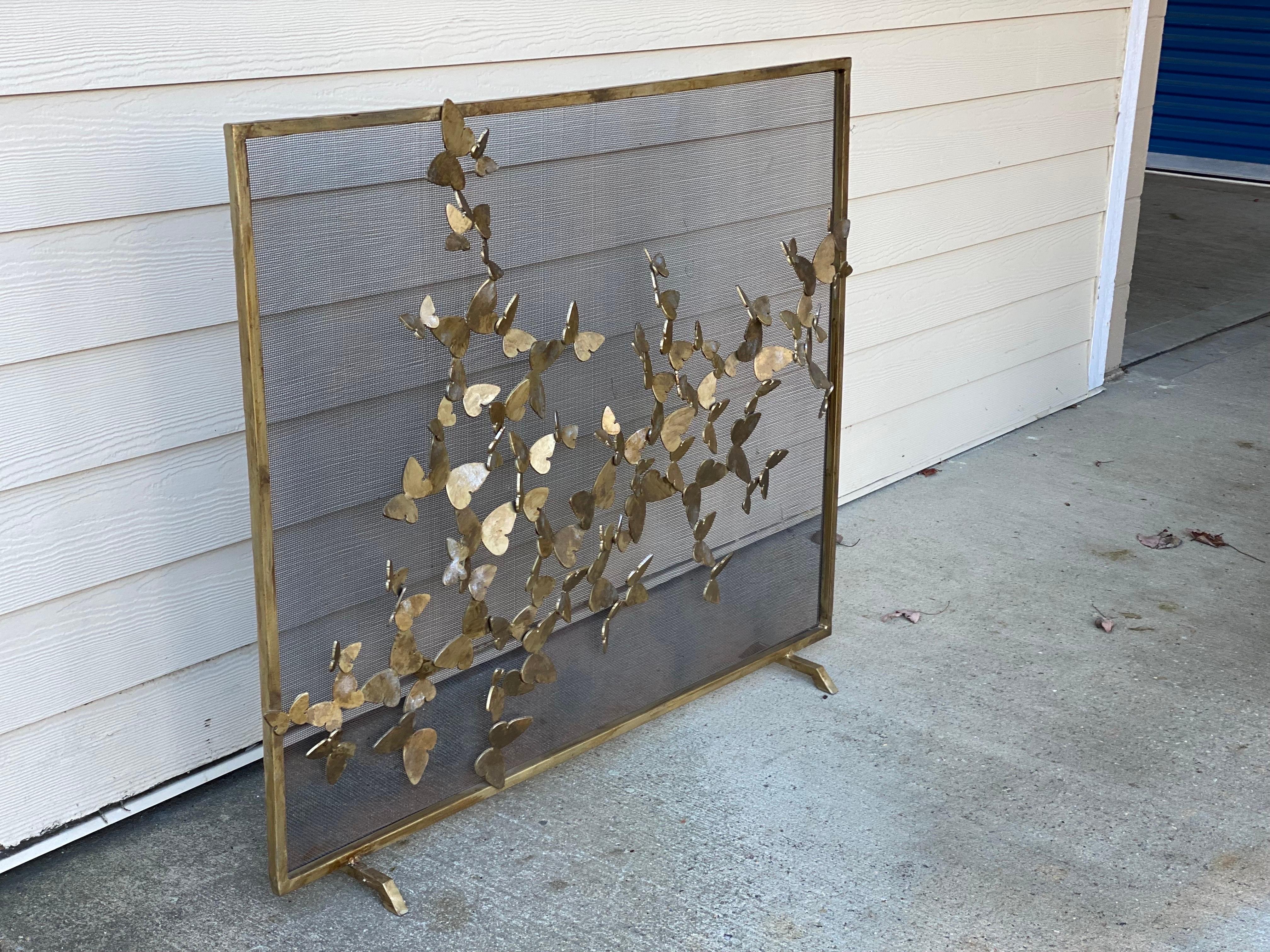 Custom fabricated Iron Fire-screen with butterflies, 21st century.
Incredible craftsmanship, this firescreen was custom fabricated with three dimensional butterflies whimsically fluttering around the front of the screen and painted in a medium sheen