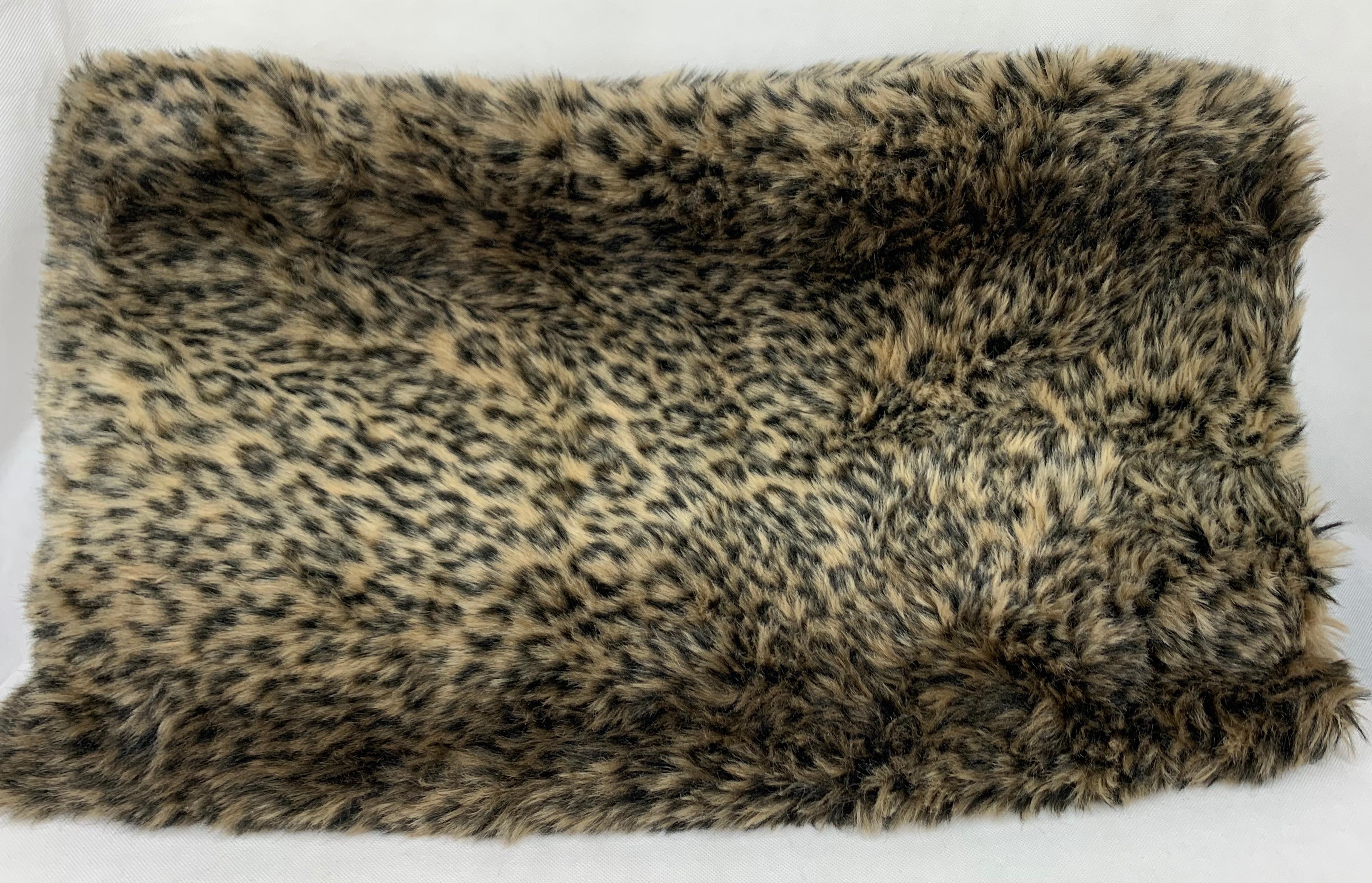 Luxurious faux leopard throw made by a talented seamstress for our shop. Trimmed with a soutache style of passementerie and lined with black velvet.
Dry clean.
Measures: 52
