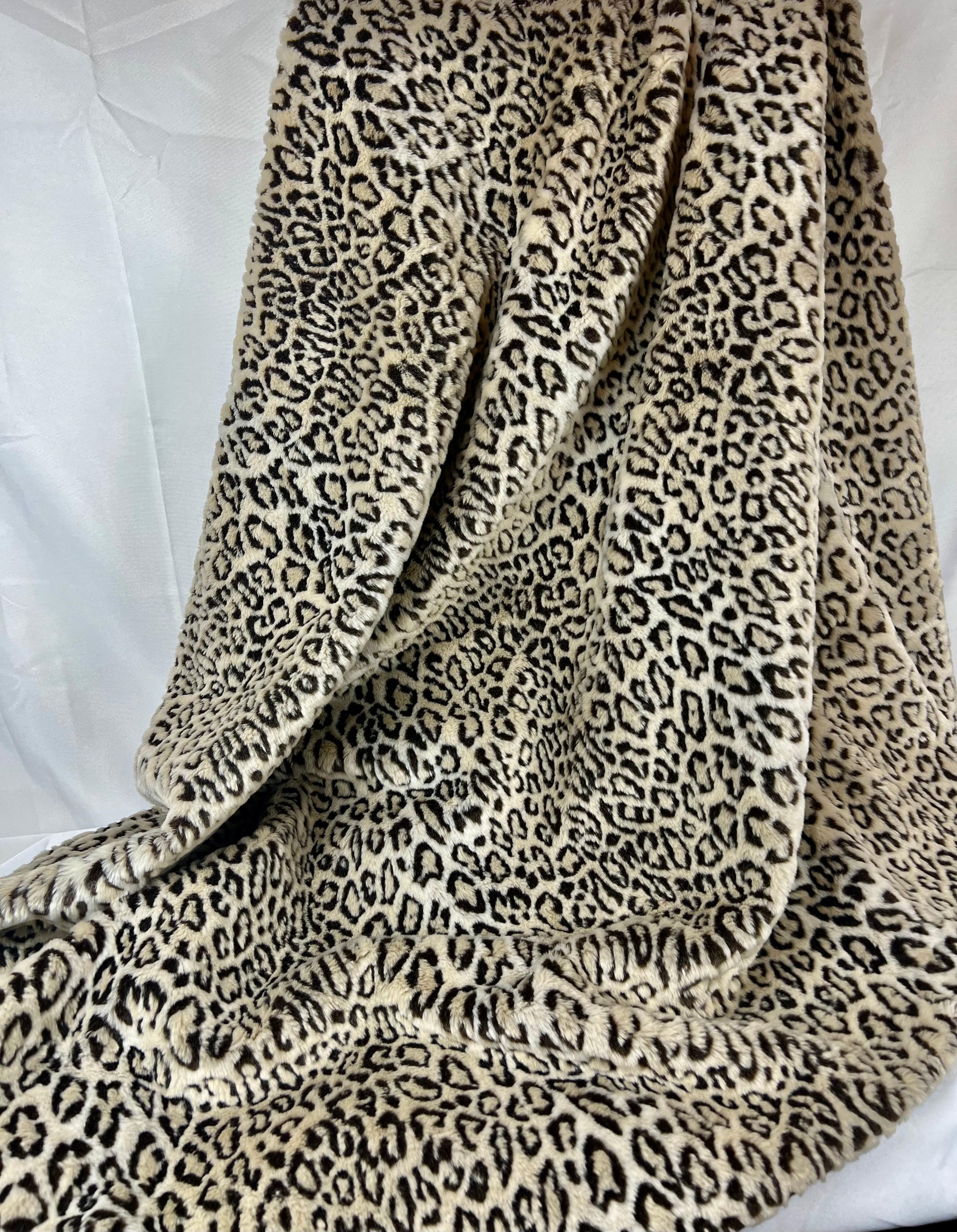 This luxurious faux snow leopard throw was created by a talented seamstress for our shop. Trimmed with a soutache type of passementerie and bullion fringe in a neutral palette. Lined with black velvet.
Dry Clean only.
L-58” x W-48