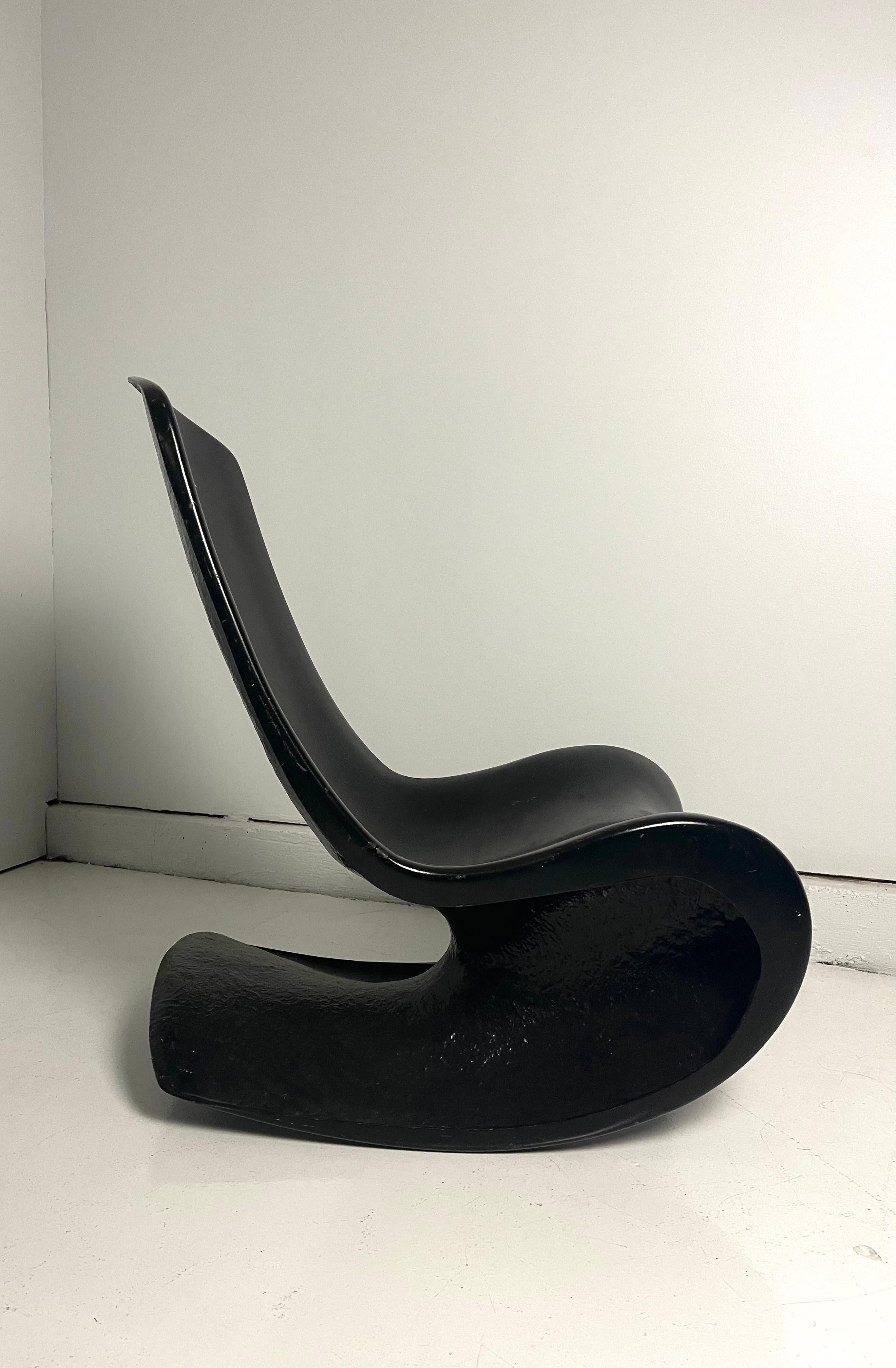 Custom one of a kind fiberglass rocker. Stylish and completely unique this surprisingly comfortable rocker can slide into any-style interior (or outdoor space) with ease. Shows some wear to body of chair. Can be professionally redone with auto-paint