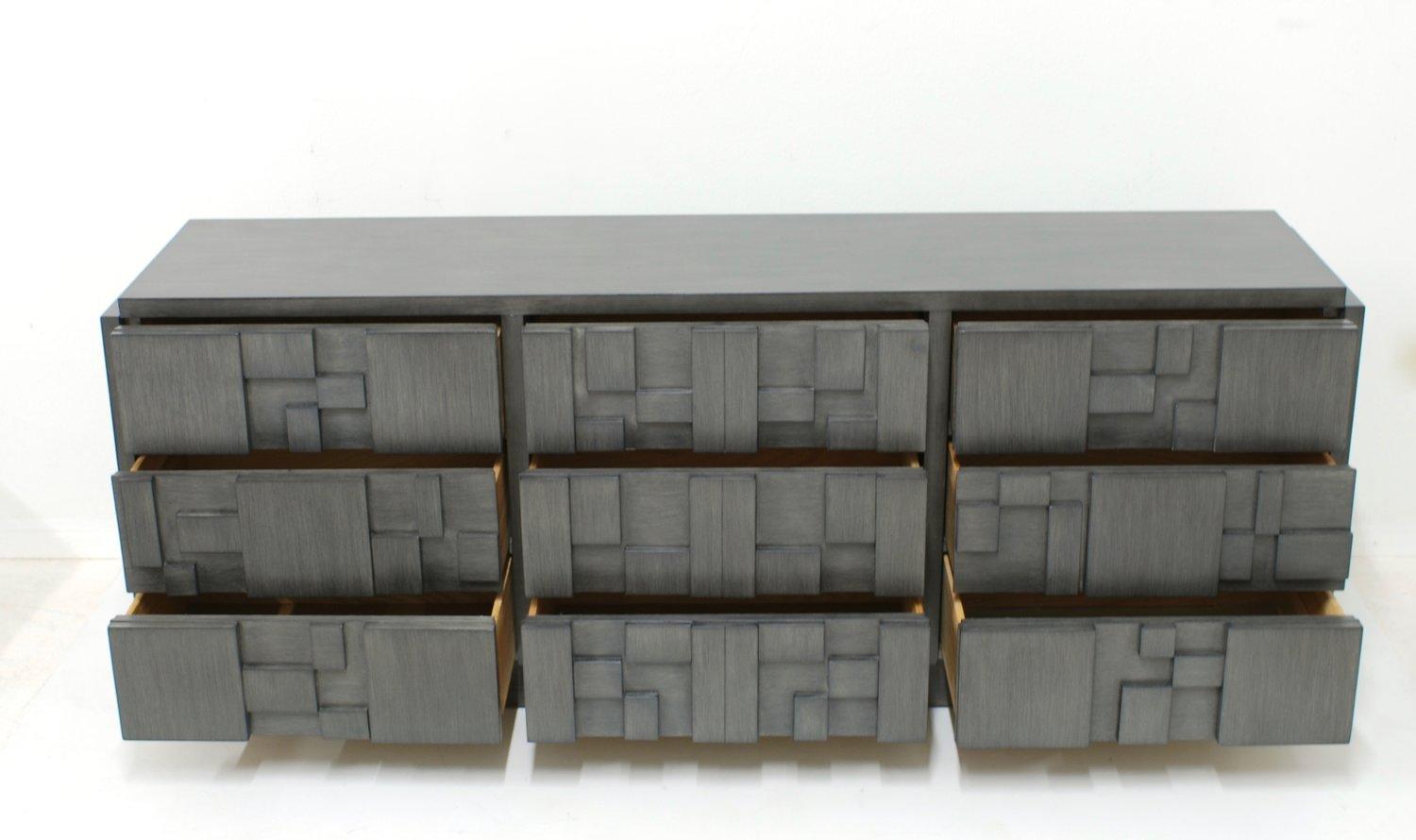 This nine-drawer Brutalist dresser manufactured by The Lane Furniture Company in the 1960s, has been refinished in a custom finish. The Brutalist styling on the block fronts is a reference to the Paul Evans Cityscape line.

 